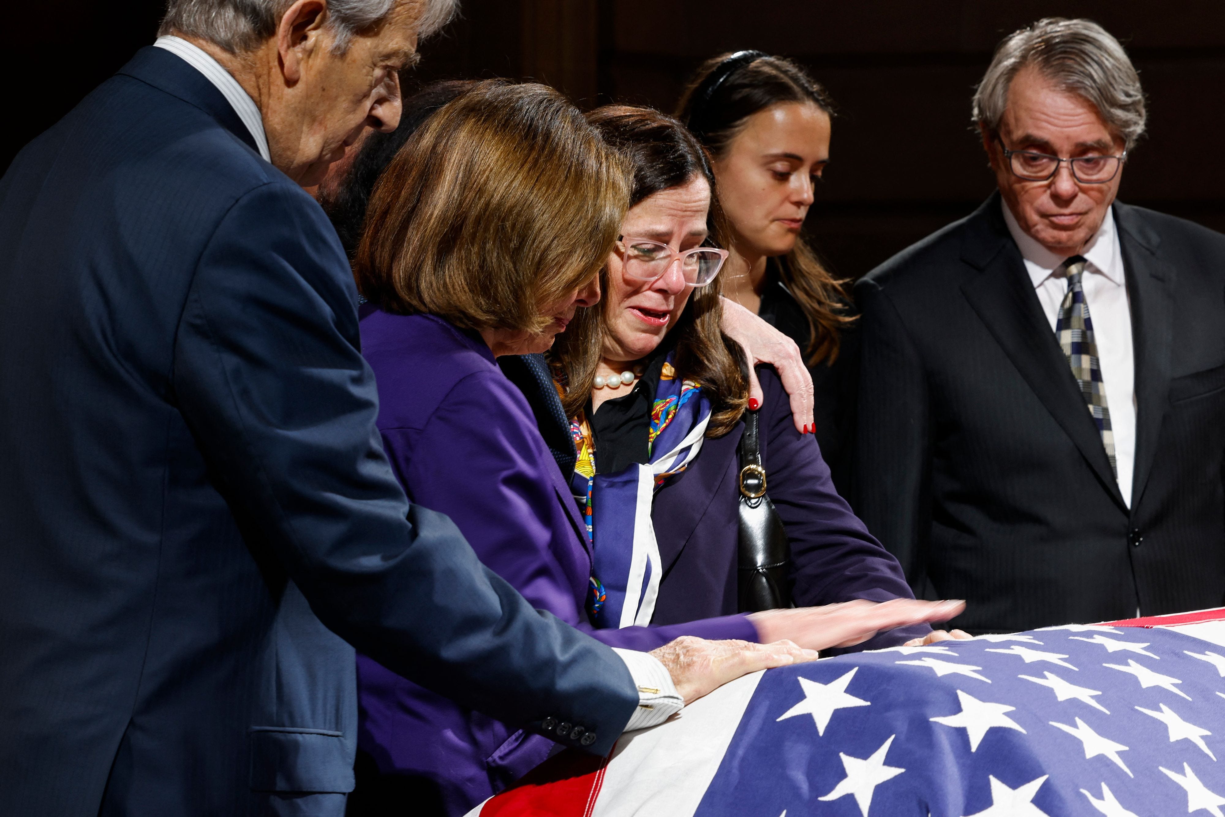 TOPSHOT - Former US House Speaker Nancy Pelosi (D-CA (2L), comforts her eldest daughter Nancy Prowda as she, alongside her husband Paul Pelosi, Eileen Mariano, granddaughter of Dianne Feinstein, and Rick Mariano, son-in-law of Dianne Feinstein,    pay their respects to the late US Senator Dianne Feinstein (D-CA), as her body lies in state in the Rotunda of City Hall in San Francisco, California, on October 4, 2023. (Photo by Jessica Christian / POOL / AFP) (Photo by JESSICA CHRISTIAN/POOL/AFP via Getty Images) ORIG FILE ID: AFP_33XF9LU.jpg