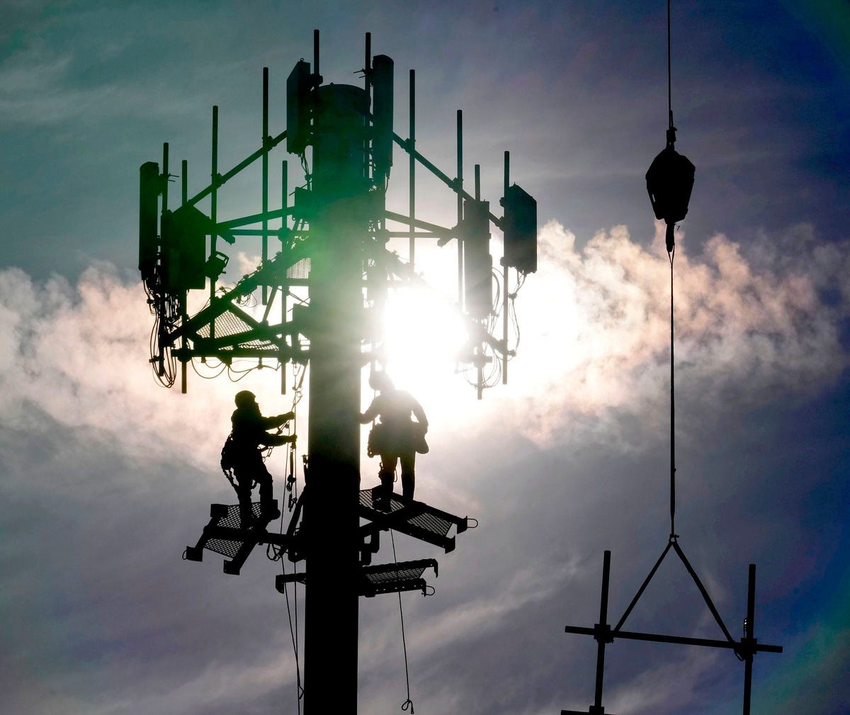 A crew with Tower Warriors Construction, out of Plainfield, Illinois work on installing cellular equipment for Dish Network Wireless on a cell communications tower in the Fox Point shopping plaza on West Brown Deer Road on Tuesday, March 21, 2023.    Wild Cell Tower 0783