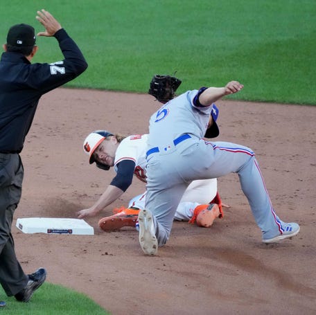 Orioles third baseman Gunnar Henderson is tagged out attempting to steal second base by Rangers shortstop Corey Seager in the ninth inning.