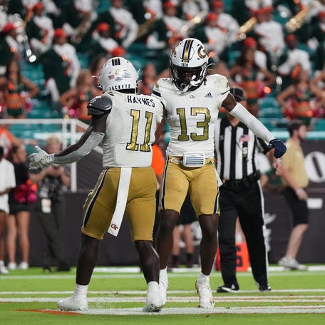Georgia Tech Yellow Jackets running back Jamal Haynes (11) celebrates his touchdown against the Miami Hurricanes with wide receiver Eric Singleton Jr. (13) in the second half at Hard Rock Stadium.