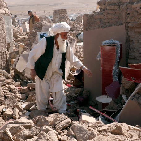 A man cleans up after an earthquake in Zenda Jan district in Herat province, of western Afghanistan, Sunday, Oct. 8, 2023. Powerful earthquakes killed at least 2,000 people in western Afghanistan, a Taliban government spokesman said Sunday. It's one of the deadliest earthquakes to strike the country in two decades. (AP Photo/Omid Haqjoo)