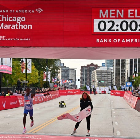 Oct 8, 2023; Chicago, IL, USA; Kelvin Kiptum of Kenya crosses the finish line of the 2023 Chicago Marathon with a new world record time of 2:00:35. Mandatory Credit: Jamie Sabau-USA TODAY Sports