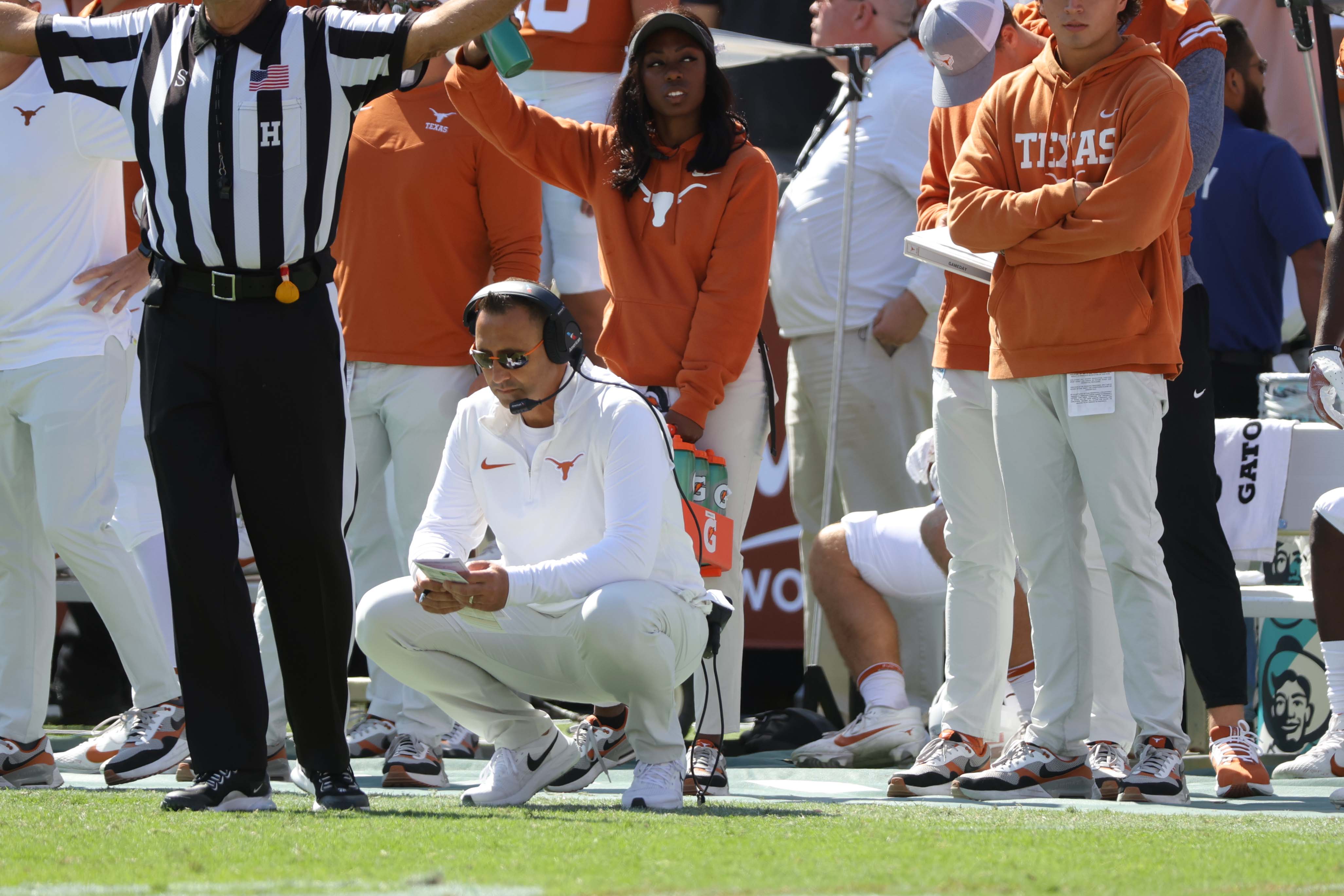 Texas coach Steve Sarkisian kneels on the sideline during the Red River Rivalry game against Oklahoma at the Cotton Bowl in Dallas, Saturday, Oct. 7, 2023.