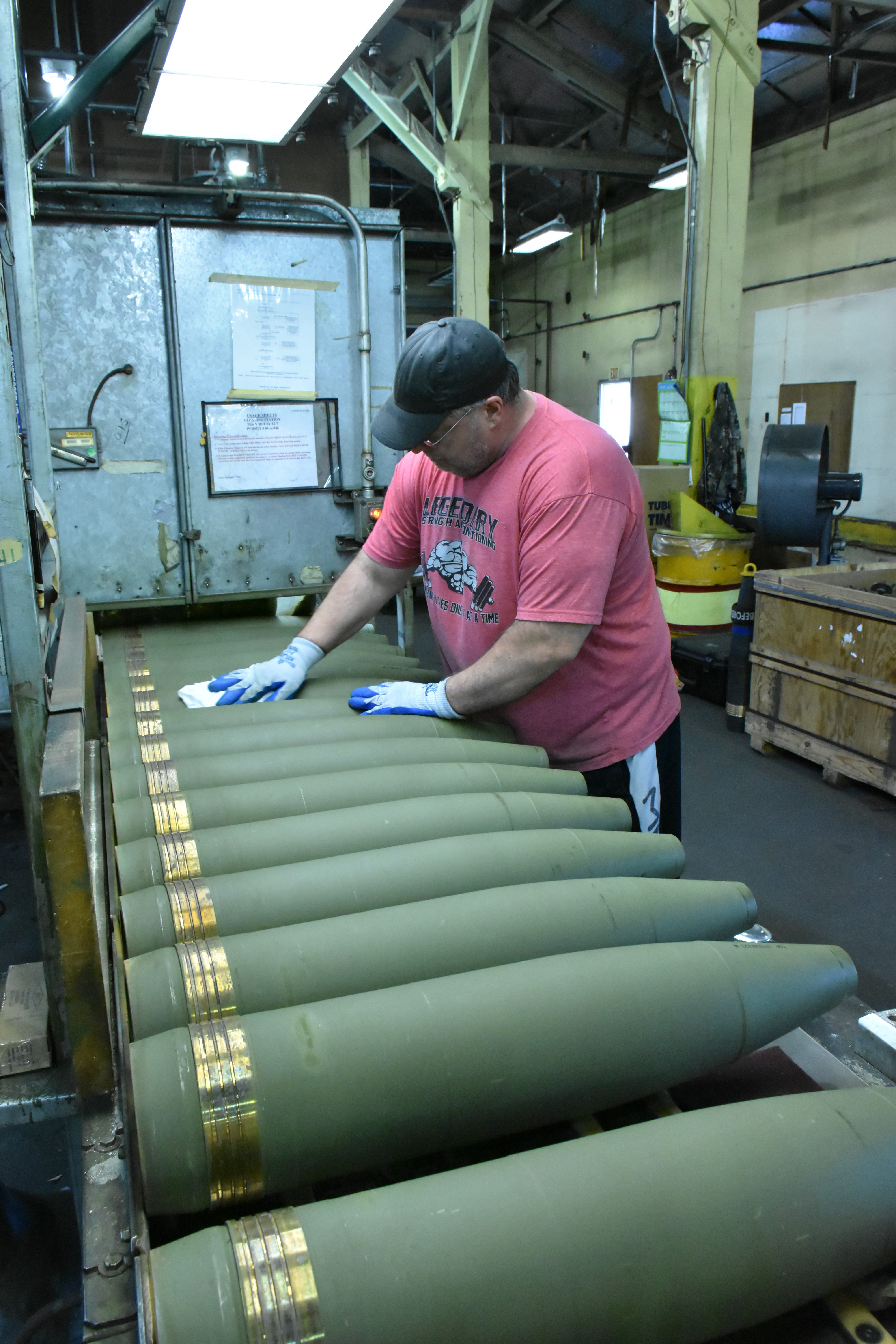 A munitions employee wipes down 155 mm casings following inspection at the Iowa Army Ammunition Plant near Middletown.