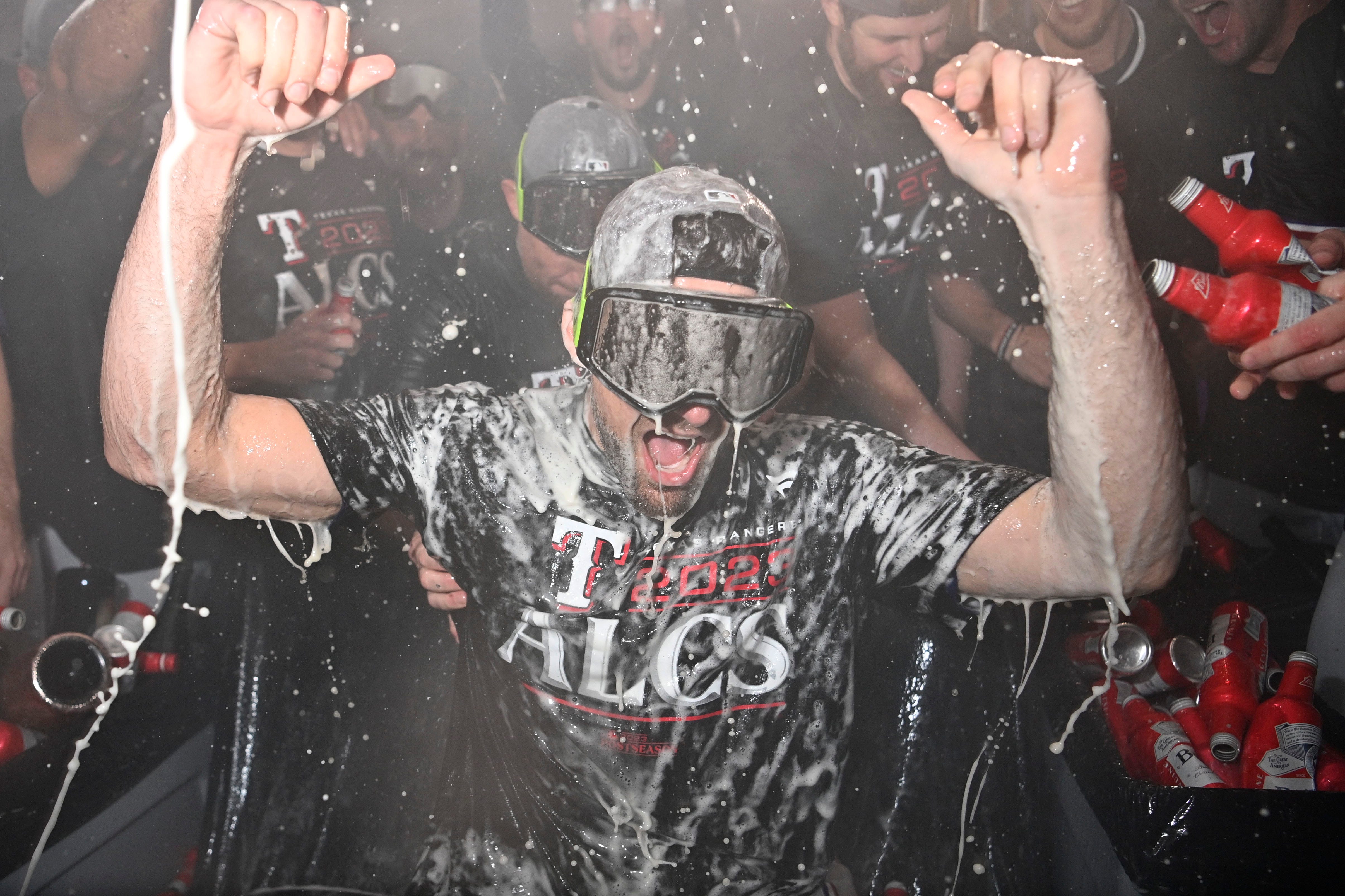 Oct 10, 2023; Arlington, Texas, USA; The Texas Rangers celebrate in the locker room after defeating the Baltimore Orioles in game three of the ALDS for the 2023 MLB playoffs at Globe Life Field. Mandatory Credit: Jerome Miron-USA TODAY Sports