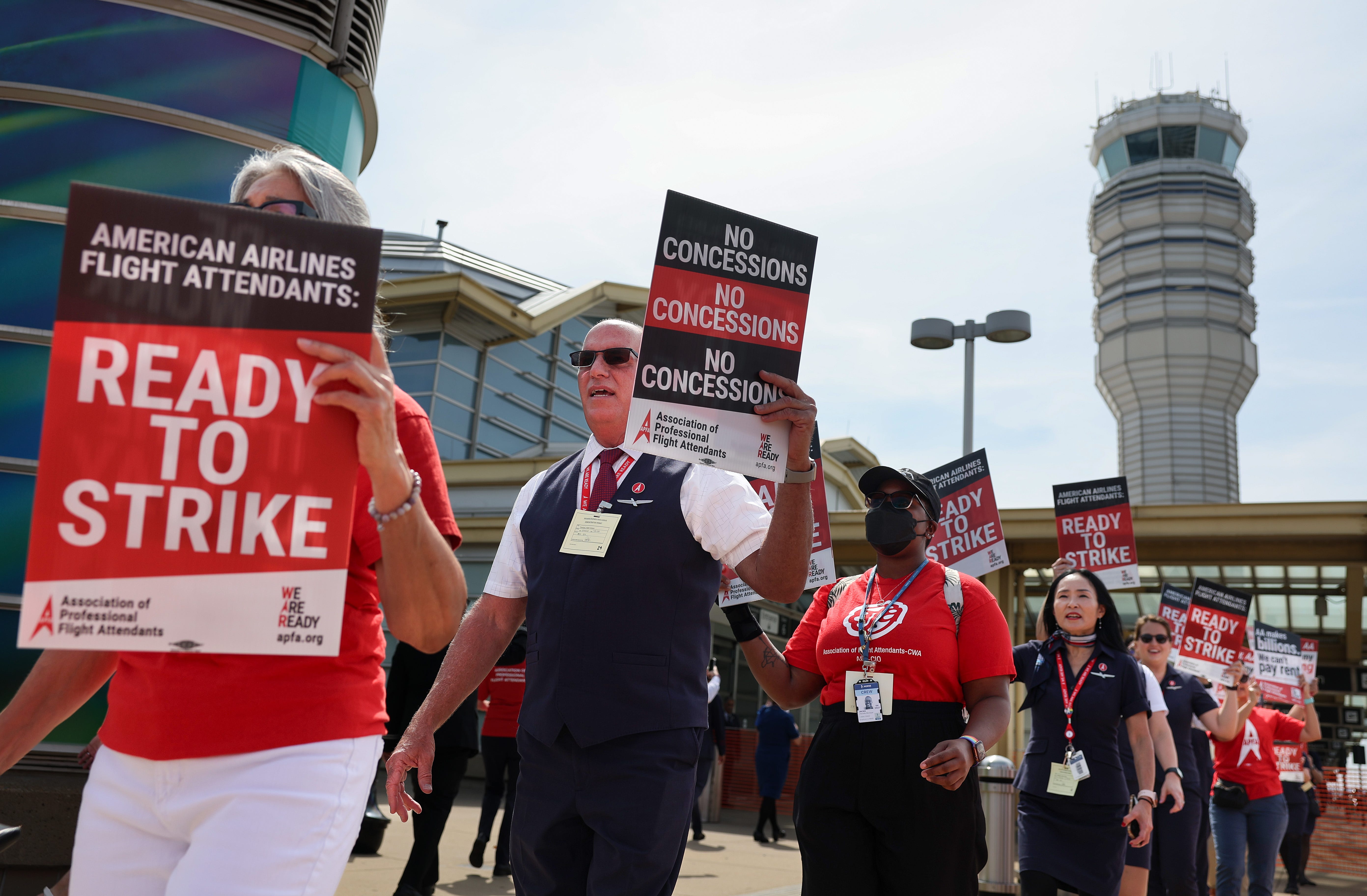 American Airlines flight attendants, represented by the Association of Professional Flight Attendants (APFA), picket outside Ronald Reagan National Airport on Aug. 30, 2023 in Arlington, Va. Flight attendants, fellow union members, and supporters participated in the country-wide picket as the APFA voted to authorize a strike as they seek an increase in compensation and a more flexible work schedules.
