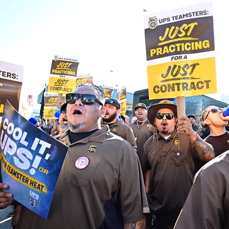 UPS workers hold placards at a rally held by the Teamsters union on July 19, 2023 in Los Angeles, ahead of an Aug. 1st deadline for an agreement on a labor contract deal and to avert a strike that could lead to billions of dollars in economic losses.