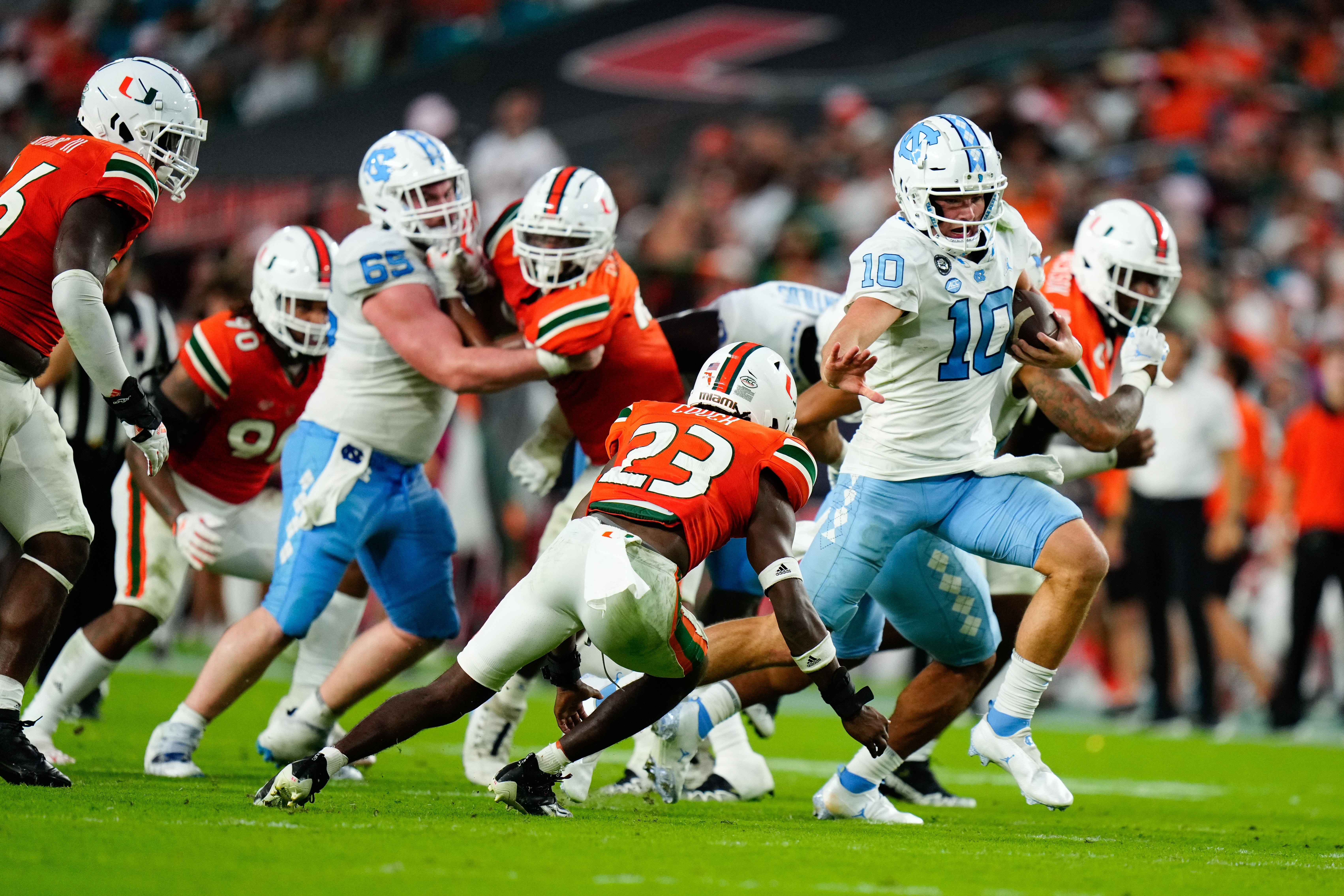 North Carolina quarterback Drake Maye (10) runs the ball against Miami (Fla.) during their 2022 game at Hard Rock Stadium.