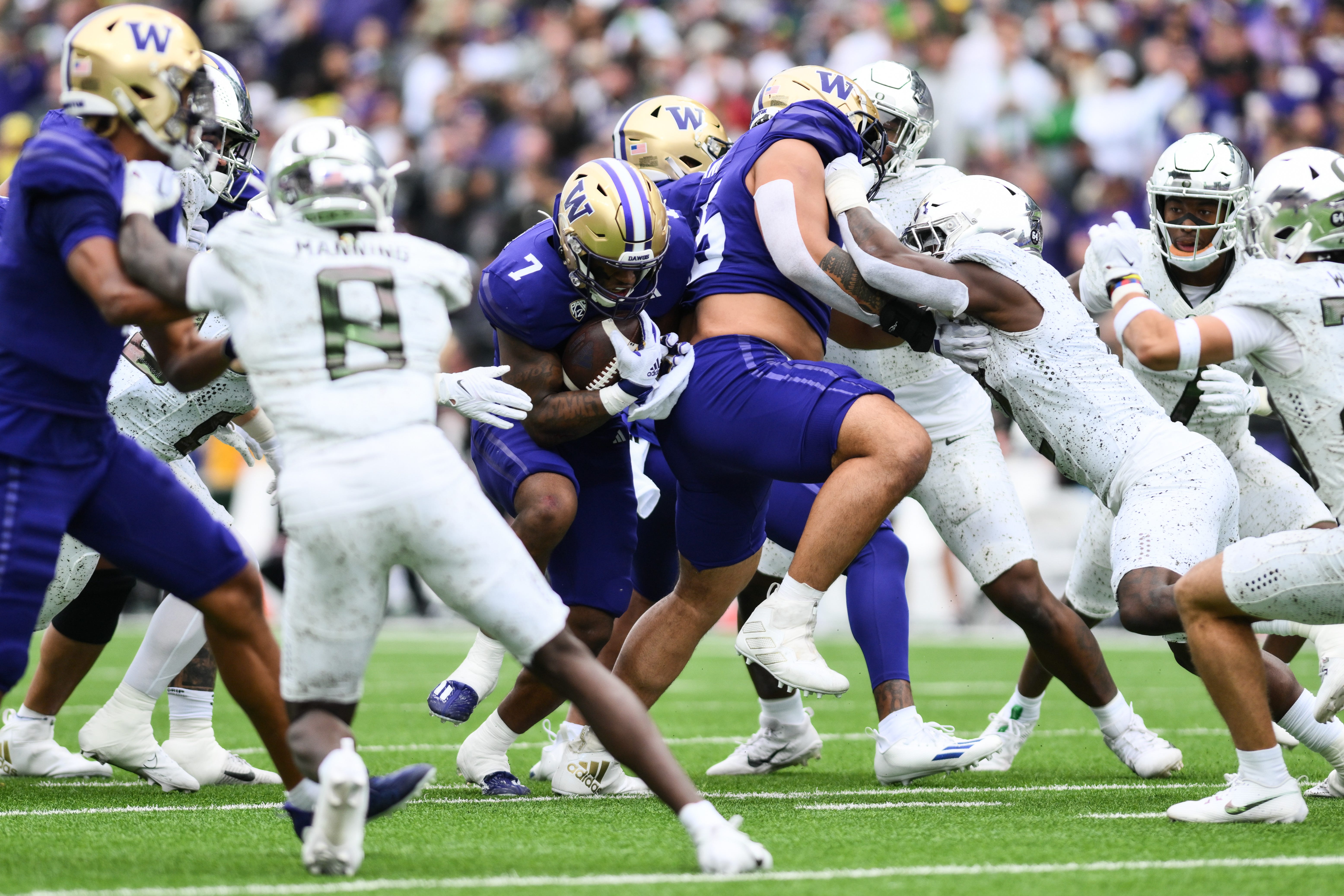 Washington running back Dillon Johnson (7) carries the ball against the Oregon defense during the first half at Alaska Airlines Field at Husky Stadium.