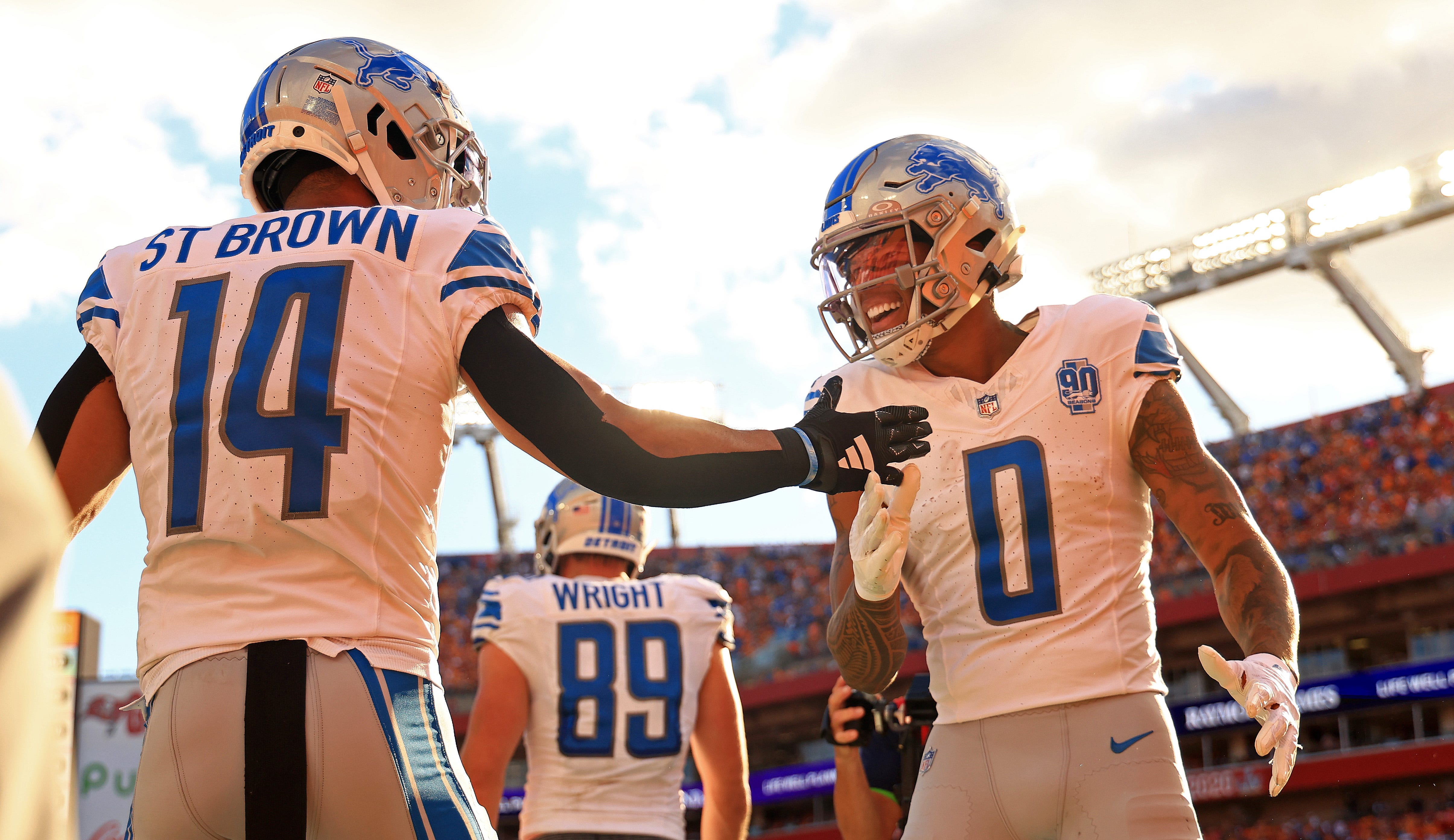 Marvin Jones Jr. #0 and Amon-Ra St. Brown #14 of the Detroit Lions celebrate a touchdown during a game against the Tampa Bay Buccaneers at Raymond James Stadium on October 15, 2023 in Tampa, Florida.