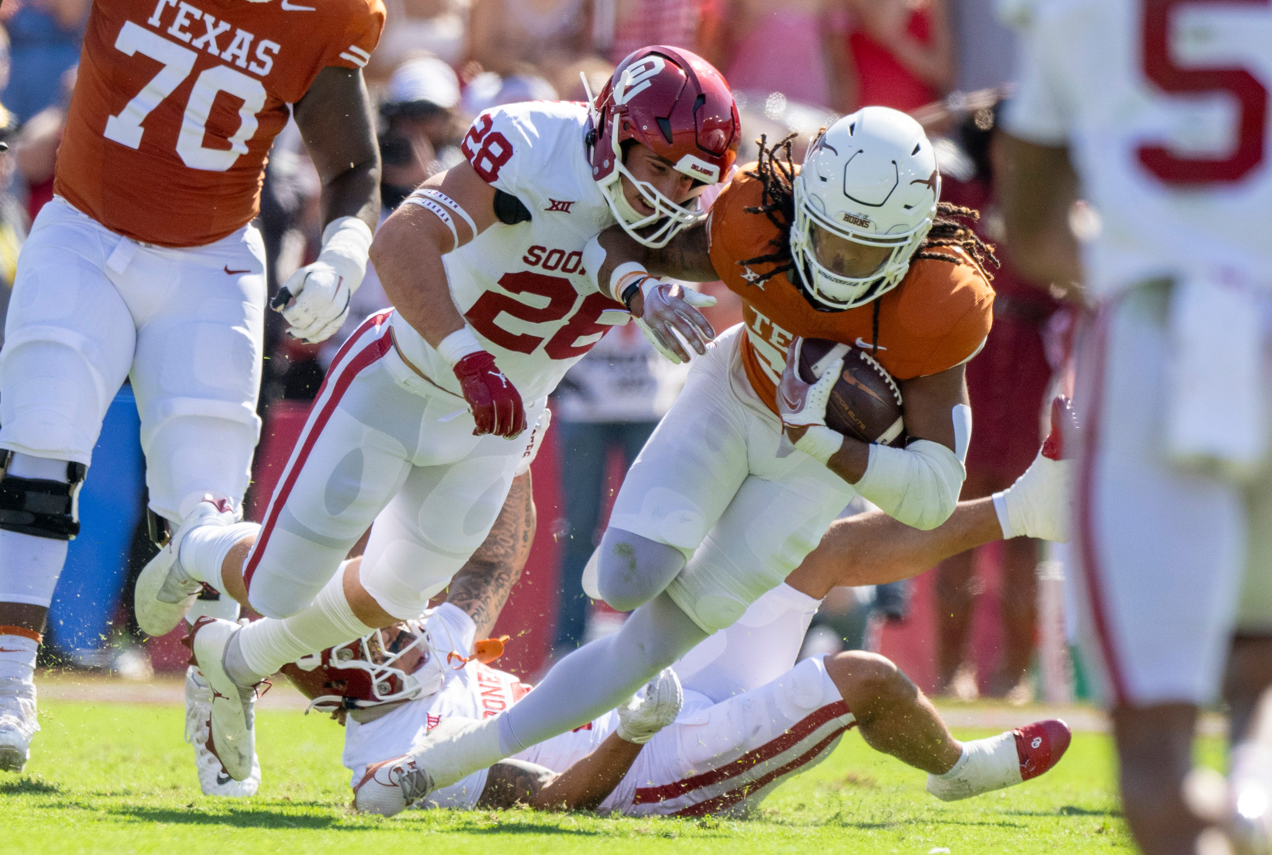 Oklahoma linebacker Danny Stutsman (28) tackles Texas running back Jonathon Brooks during their 2023 game at the Cotton Bowl.