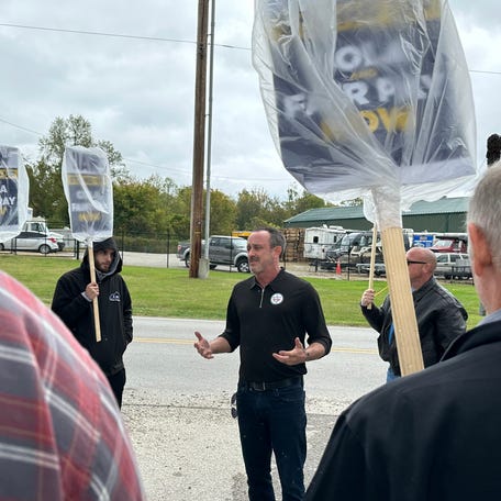 Todd Dunn, president of UAW Local 862, joins his membership while on strike outside of the Ford Kentucky Truck Plant on Chamberlain Lane, Monday, Oct. 16, 2023, in Louisville, Kentucky. Some 9,000 Louisville area workers are part of the nationwide autoworkers strike.