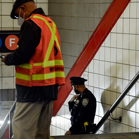NYPD officers investigate the attack that took place at the 5 Av-53 St subway station in Manhattan on Wednesday, Oct 18, 2023 in which a customer was pushed against a train by an assailant and fell to the roadbed, suffering critical injuries.