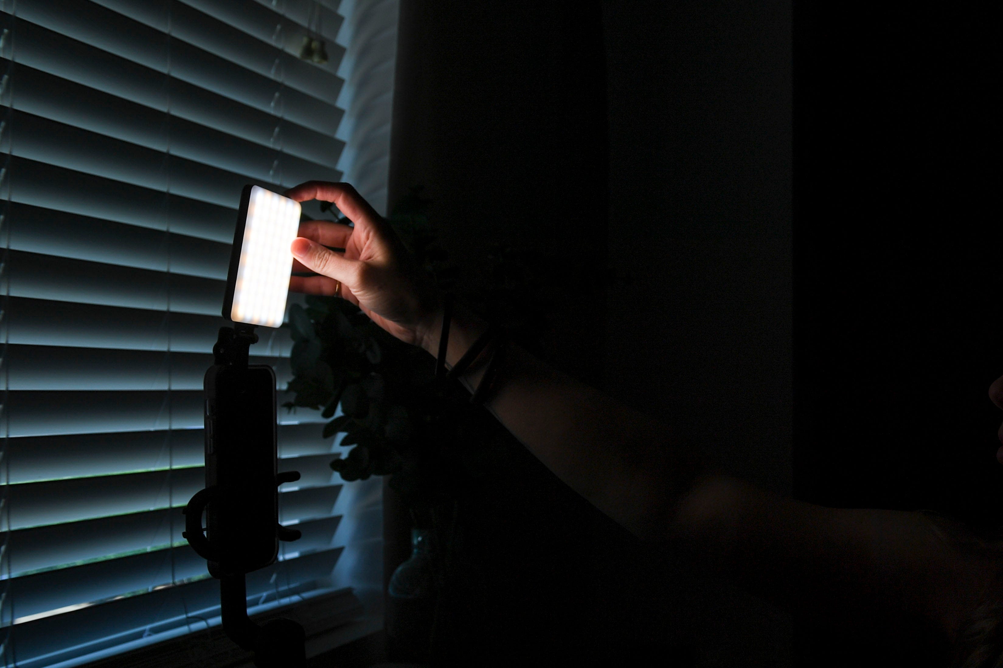 Bailey Lavender, a social media influencer and hairstylist, turns on her lighting before going on Instagram live in her hair studio where she films most of her content on Aug. 23, 2023.