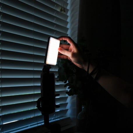 Bailey Lavender, a social media influencer and hairstylist, turns on her lighting before going on Instagram live in her hair studio where she films most of her content on Aug. 23, 2023.