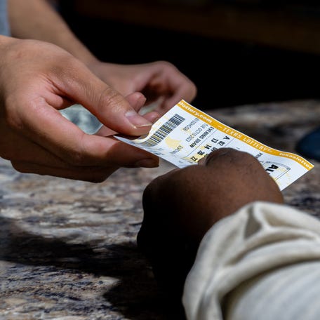 AUSTIN, TEXAS - OCTOBER 10: A customer purchases a Powerball lottery ticket at the Brew Market & Cafe on October 10, 2023 in Austin, Texas. The Powerball jackpot has grown to over $1.7 billion, making it the second largest jackpot in history. (Photo by Brandon Bell/Getty Images)