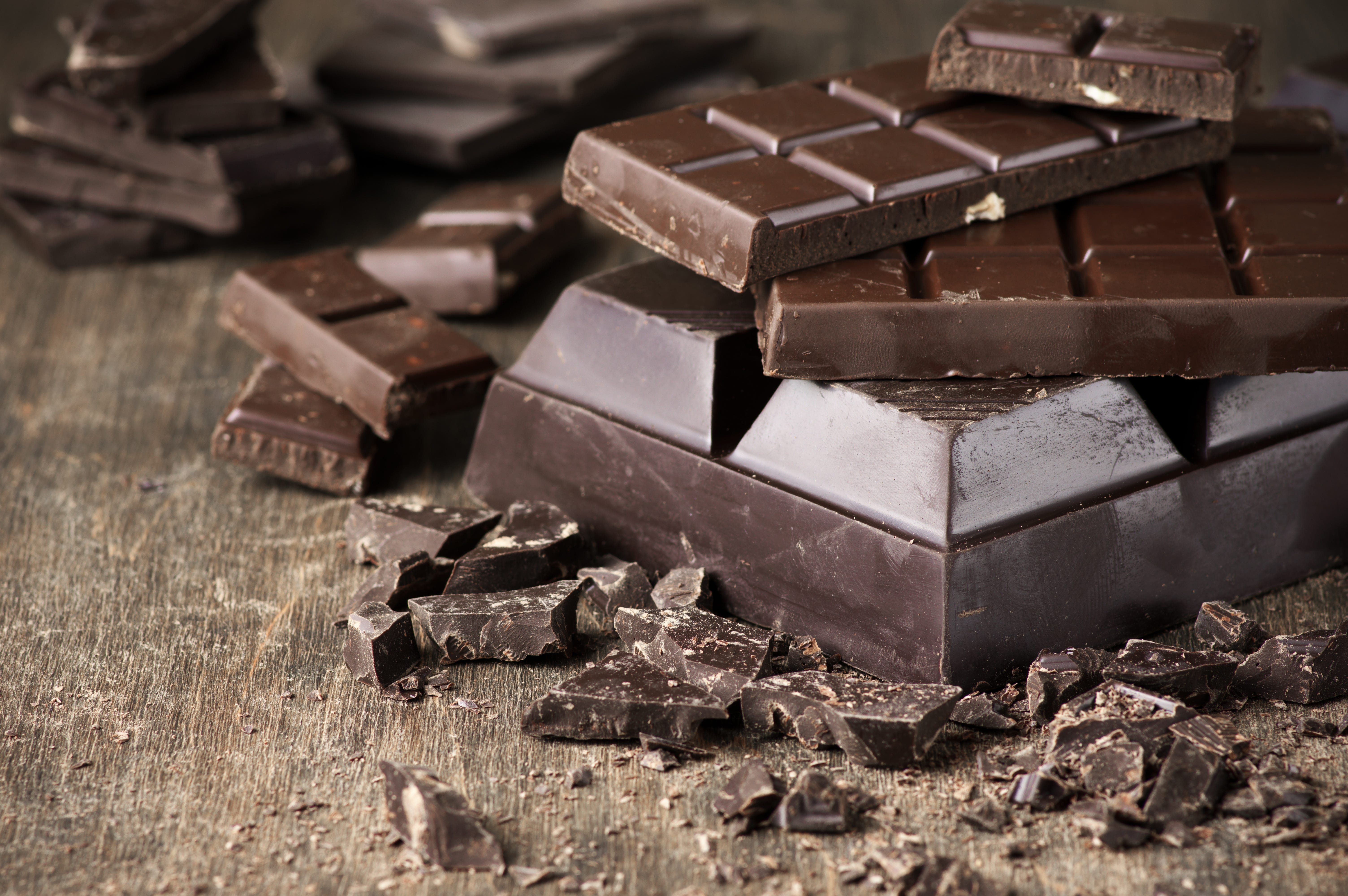 Assorted dark chocolate bars and chopped chocolate on vintage wooden background.    Credit:iStockphoto, Getty Images [Via MerlinFTP Drop]