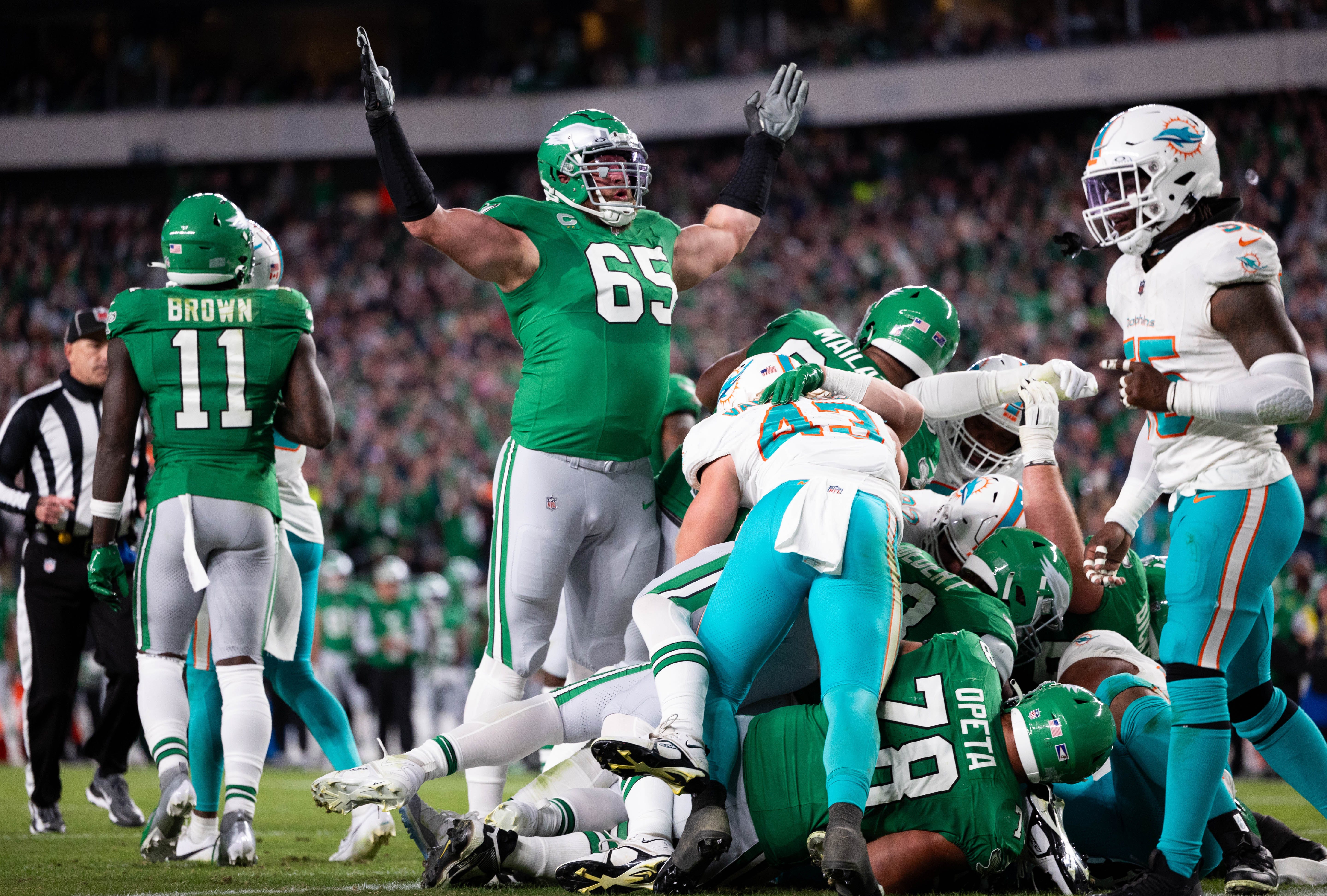 Philadelphia Eagles offensive tackle Lane Johnson (65) reacts after a Jalen Hurts (1) touchdown on a quarterback sneak against the Miami Dolphins during the second quarter at Lincoln Financial Field.