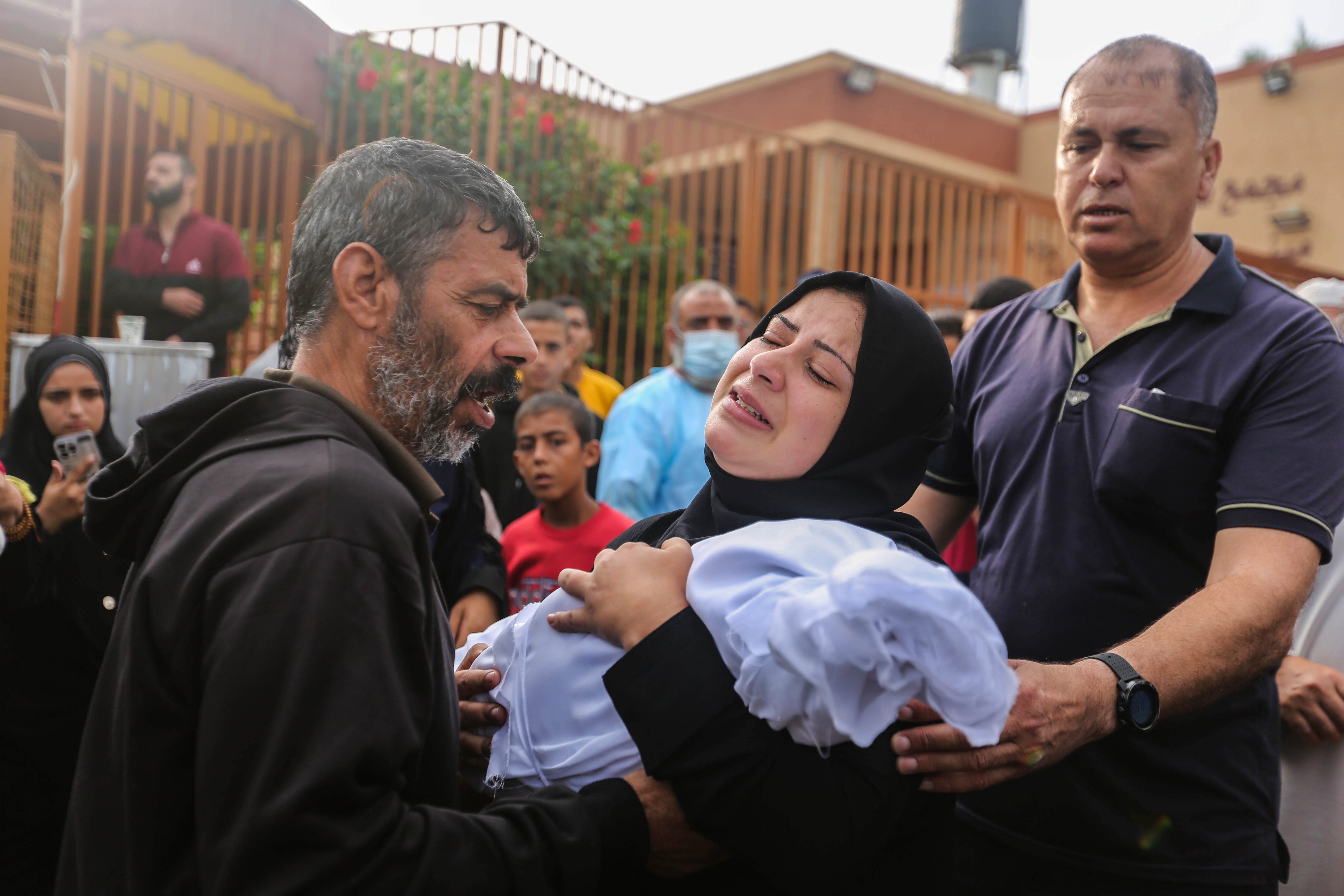 People mourn as they collect the bodies of Palestinians killed in Israeli air raids on Oct. 28, 2023, in Khan Yunis, Gaza. Heading into a third week of heavy bombing from Israel, Gaza buckles under a shortage of basic needs, including fuel. At the same time, several neighborhoods in the Gaza strip have been wiped out, thousands have died, and hundreds of thousands have been displaced. On Oct. 7, Hamas launched a deadly attack in southern Israel that sparked a   retaliatory siege of Gaza.