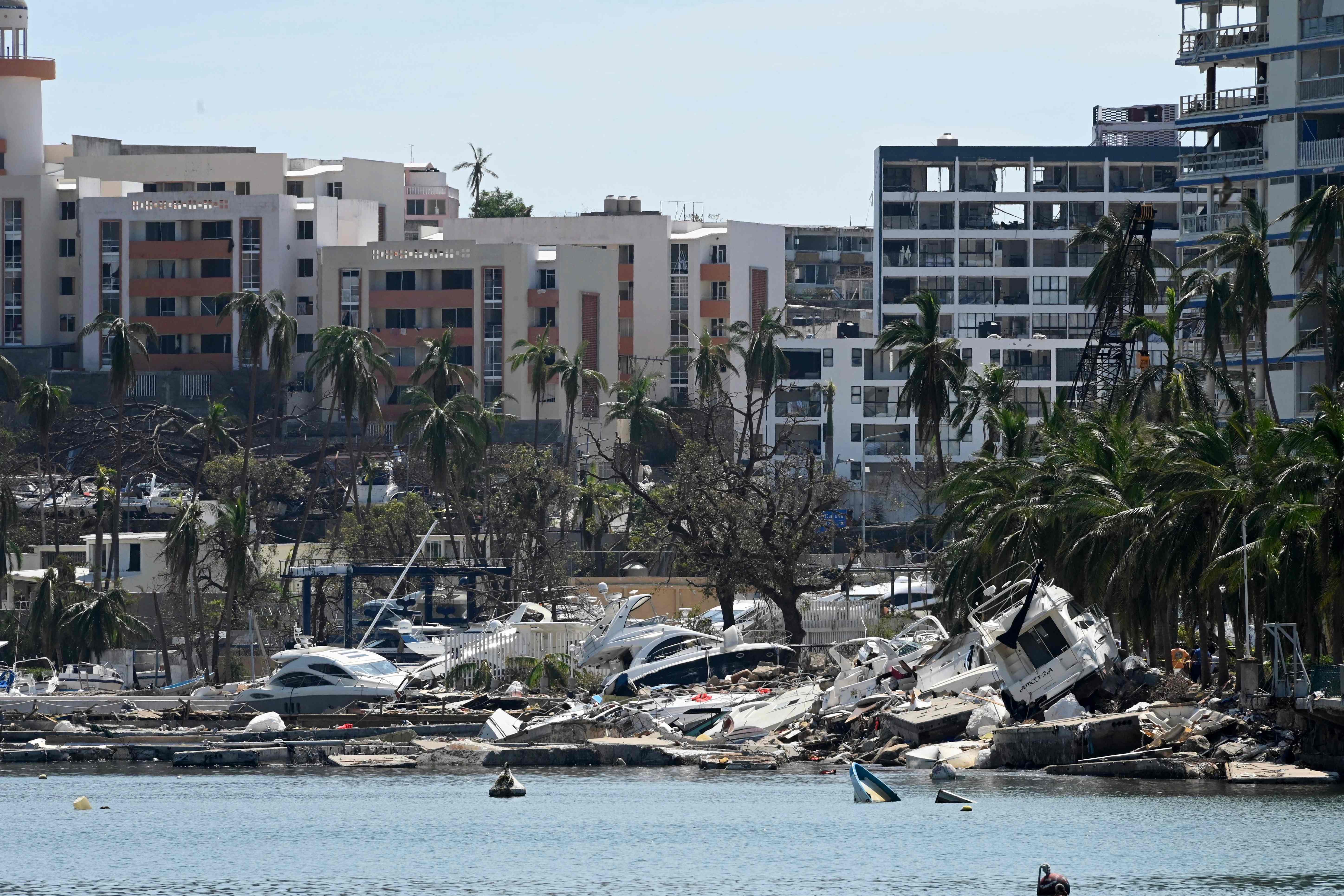 Stranded boats are seen on the beach after the passage of Hurricane Otis in the nautical area of Acapulco, Guerrero state, Mexico on October 30, 2023. Three foreigners were among at least 45 people killed when Hurricane Otis lashed Acapulco last week, authorities said Monday, as Mexico's president promised to put the devastated beachside city "back on its feet." The foreign victims -- from the United States, Britain and Canada -- were residents of   Acapulco, Evelyn Salgado, governor of the southern state of Guerrero, told reporters.