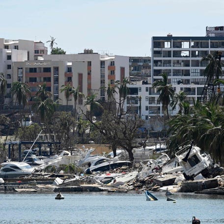 Stranded boats are seen on the beach after the passage of Hurricane Otis in the nautical area of Acapulco, Guerrero state, Mexico on October 30, 2023. Three foreigners were among at least 45 people killed when Hurricane Otis lashed Acapulco last week, authorities said Monday, as Mexico's president promised to put the devastated beachside city "back on its feet." The foreign victims -- from the United States, Britain and Canada -- were residents of   Acapulco, Evelyn Salgado, governor of the southern state of Guerrero, told reporters.