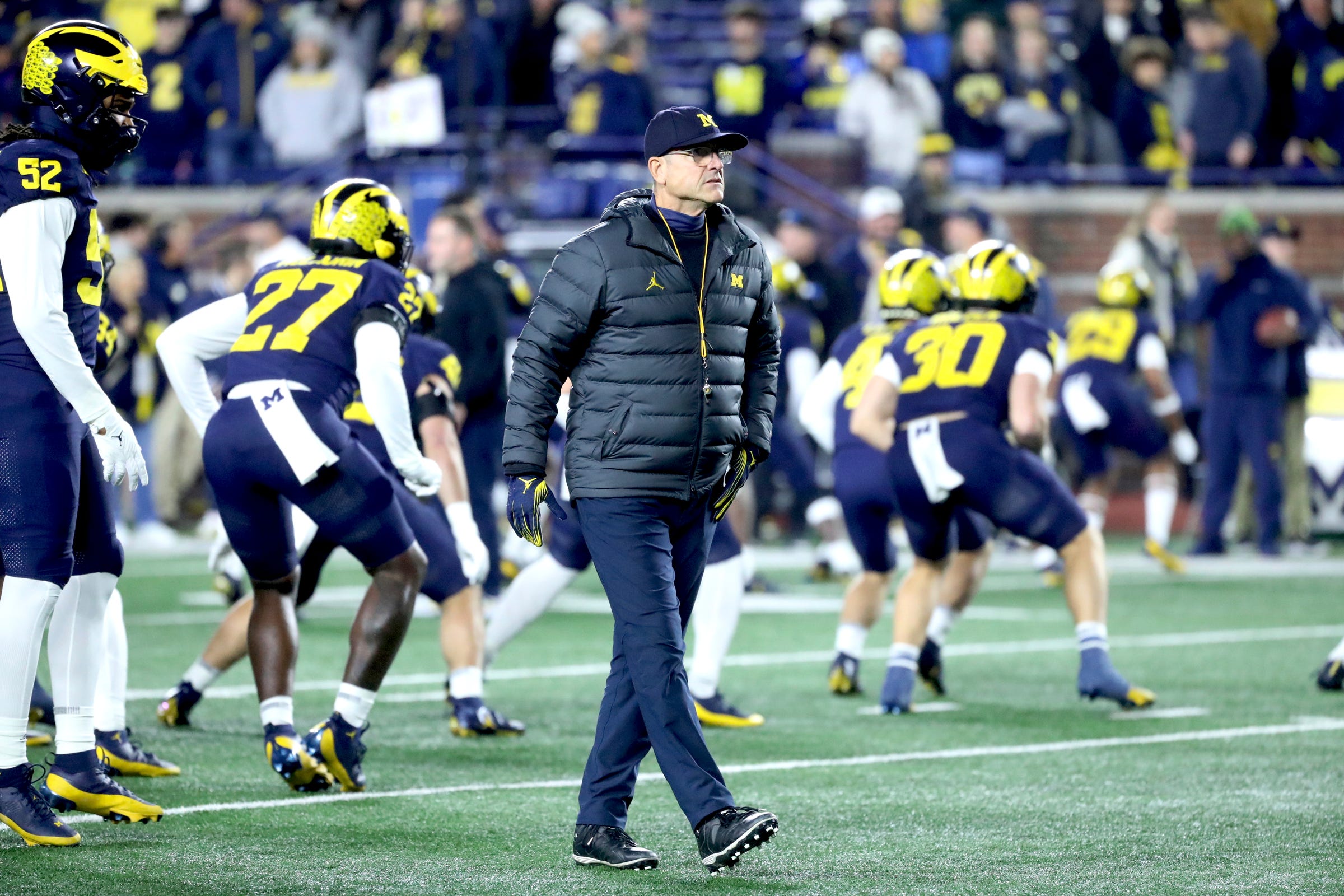 Michigan Wolverines head coach Jim Harbaugh watches his team warm up before action against the Purdue Boilermakers at Michigan Stadium, Saturday, Nov. 4, 2023.
