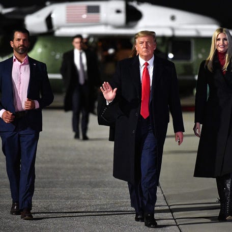 US President Donald Trump, daughter Senior Advisor Ivanka Trump and son Donald Trump Jr. make their way to board Air Force One before departing from Dobbins Air Reserve Base in Marietta, Georgia on January 4, 2021.