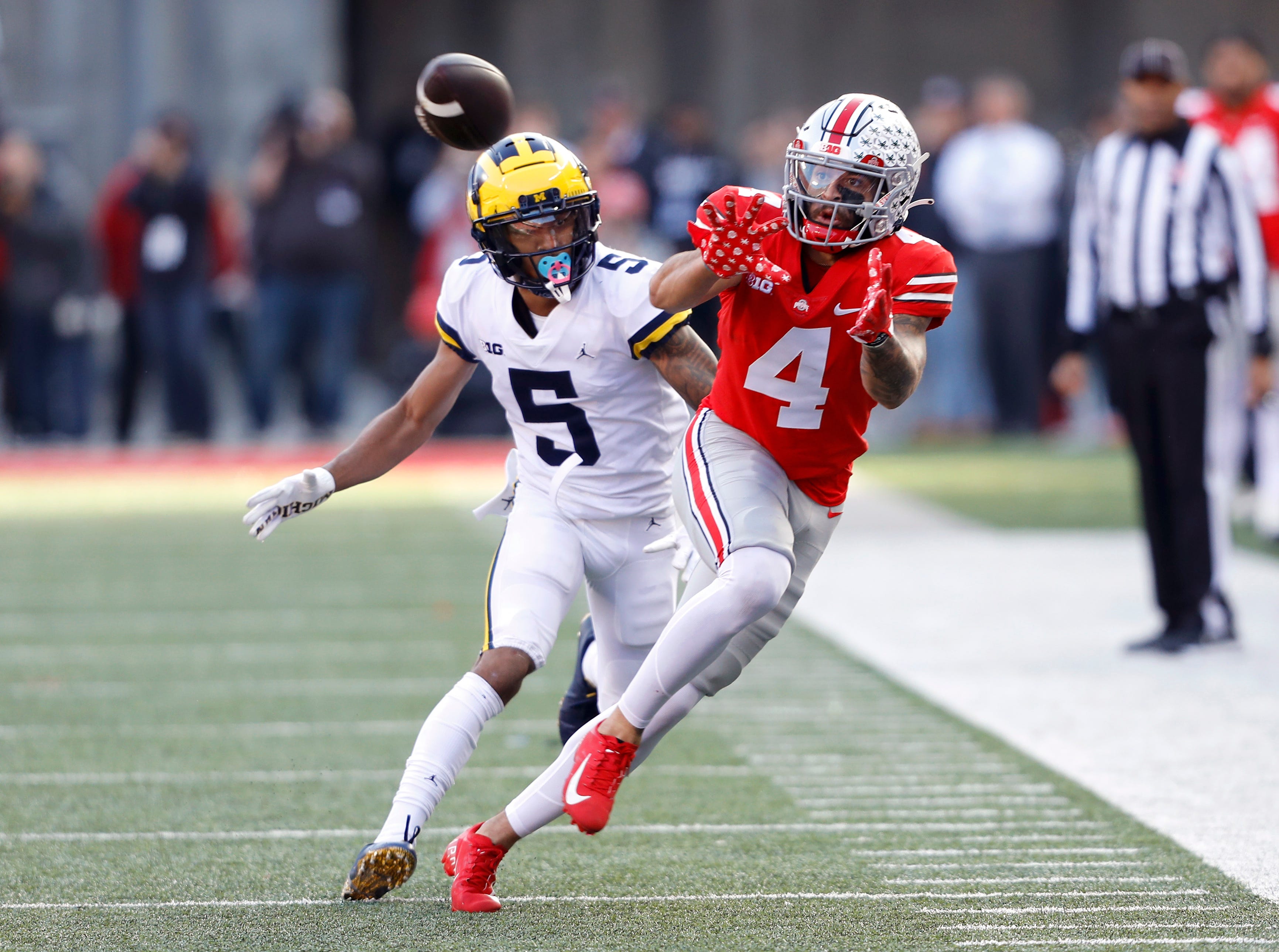 Ohio State wide receiver Julian Fleming (4) catches the pass as Michigan defensive back DJ Turner (5) defends during the second half of their 2022 game at Ohio Stadium.