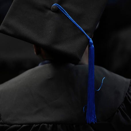 A man wears a cap, gown and tassel during a college graduation ceremony for several dozen incarerated men housed at Grafton Correctional Institution in northern Ohio.