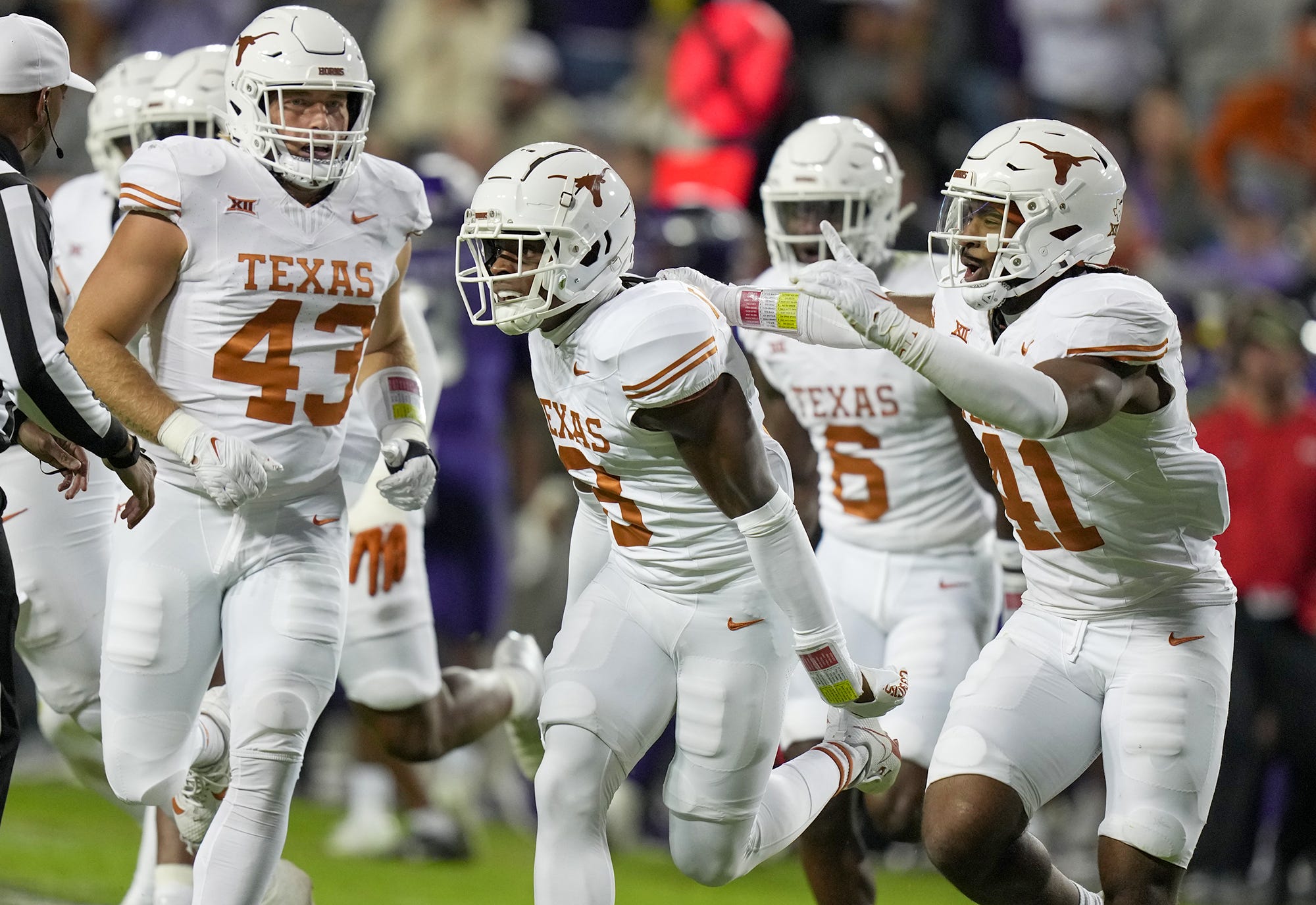Texas defensive back Terrance Brooks (8) celebrate with teammates after an interception against TCU during their game at Amon G. Carter Stadium.
