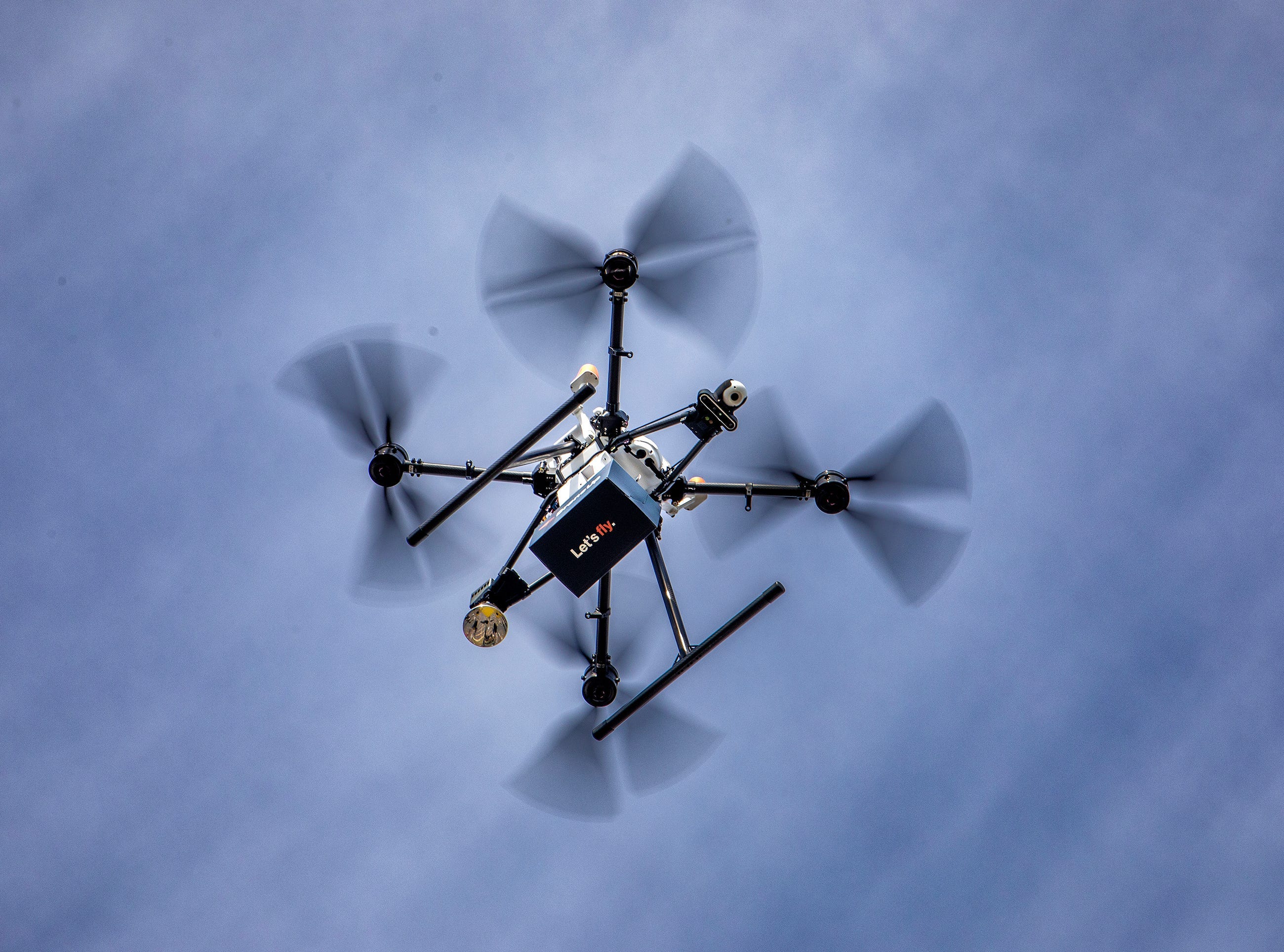 A drone test flight drops a tethered package in the parking lot of the Walmart Supercenter on Cypress Gardens Boulevard in Winter Haven, Florida.