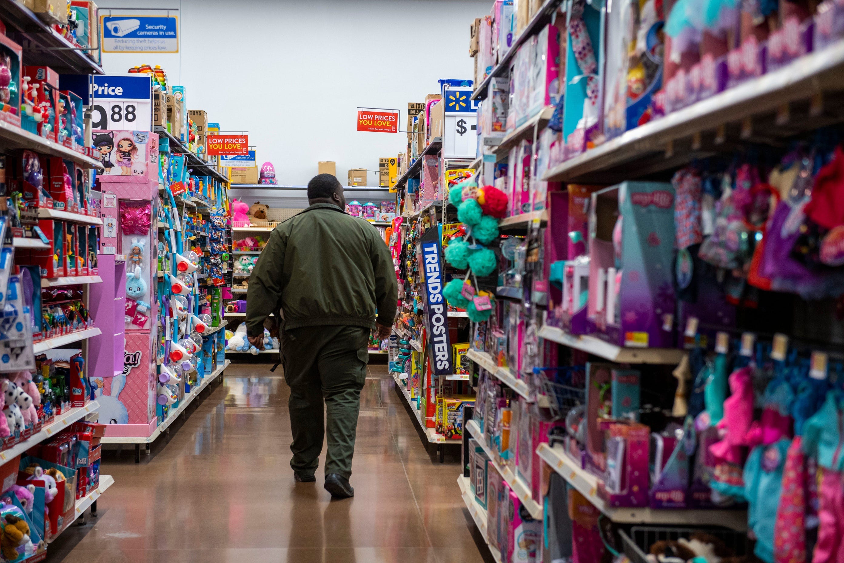 School resource office srg.Terrence Clark walks down the toy aisle looking for a puzzle for a family. Clark goes grocery shopping with the Gibson County police, assisting in groceries shopping in Humboldt, Tenn., Wednesday, March 25, 2020 to help those who are at high risk during the coronavirus pandemic.    Humboldt Walmart 09