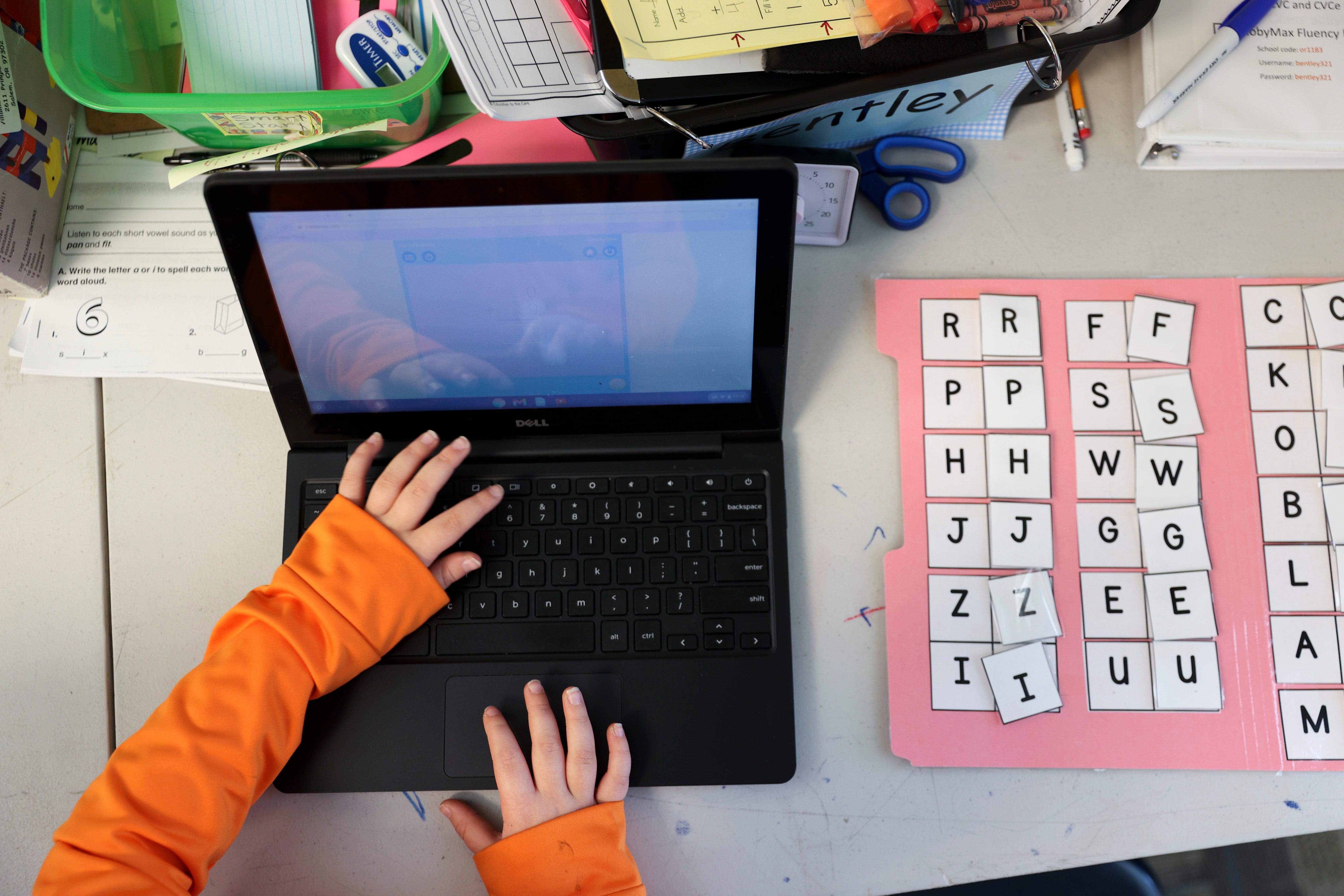 A student answers math problems on a laptop purchased with federal pandemic emergency dollars.