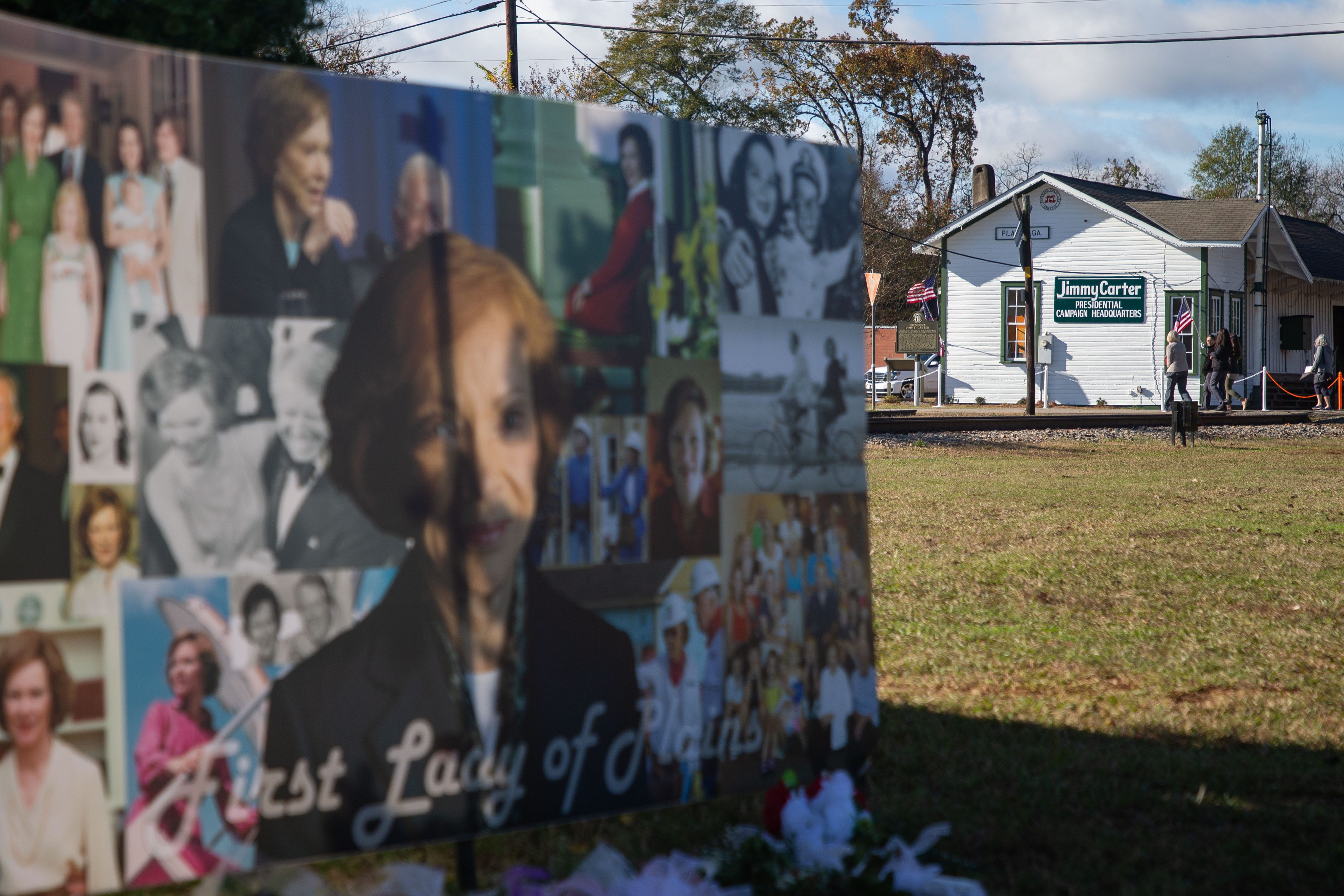 A collage of photos of former first lady Rosalynn Carter on a banner just across the railroad tracks from her husband, former president Jimmy CarterÕs campaign office in downtown Plains, Georgia on Monday, Nov. 27, 2023.