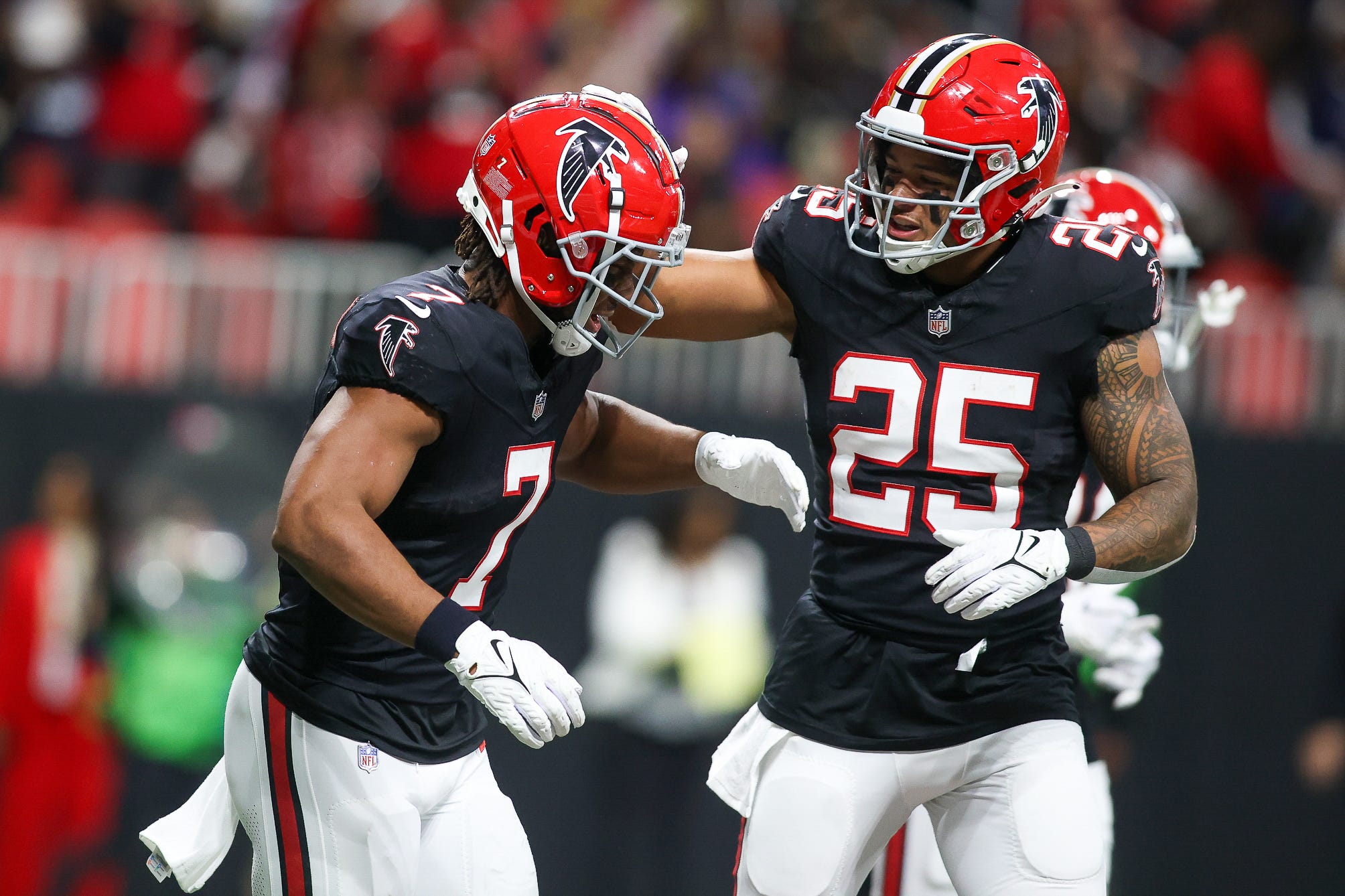 Atlanta Falcons running back Bijan Robinson (7) celebrates after a touchdown with running back Tyler Allgeier (25) against the New Orleans Saints in the second quarter at Mercedes-Benz Stadium.