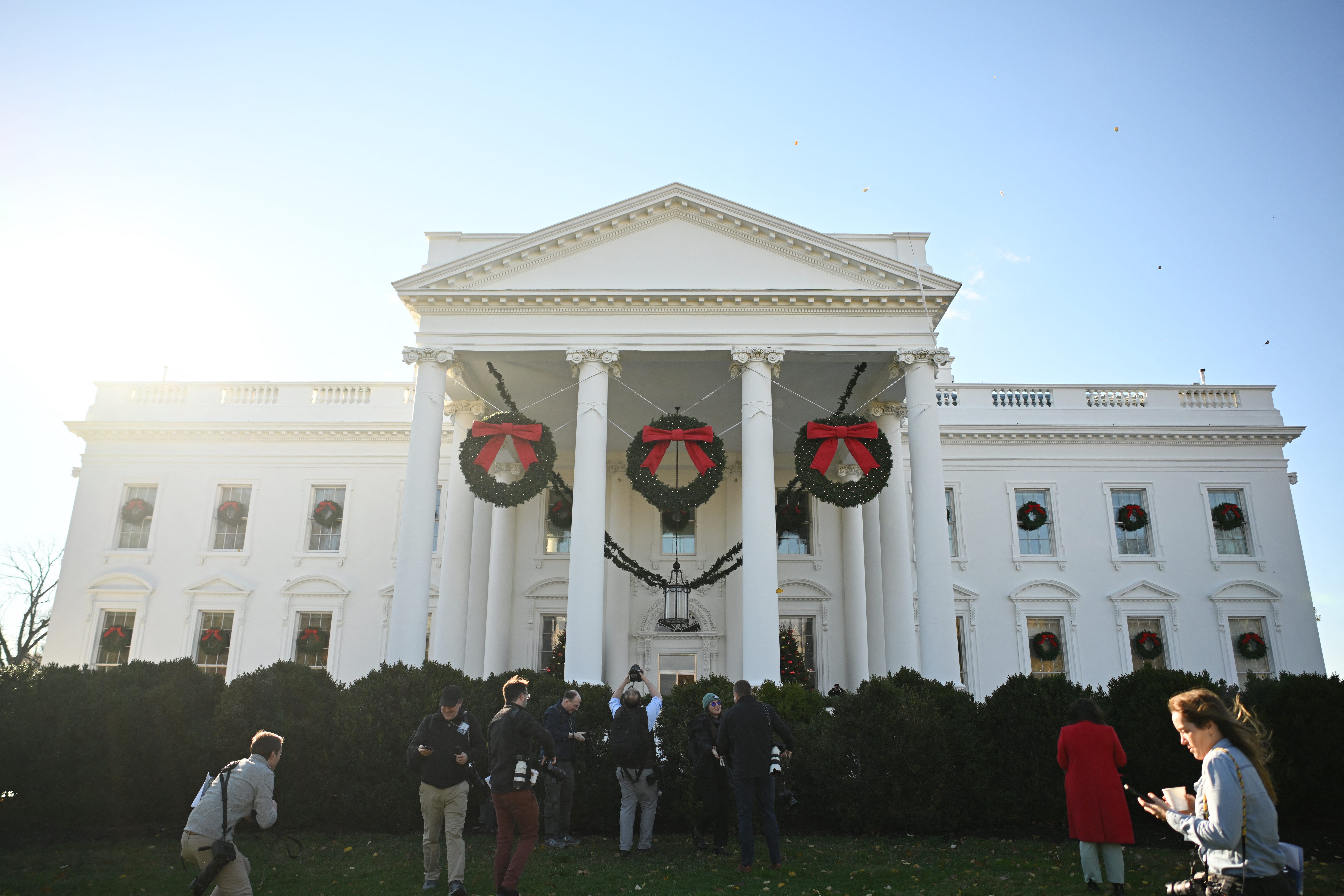 Photographers take pictures of decorations on the White House during the media preview for the 2023 Holidays at the White House in Washington, DC on November 27, 2023. The theme for the 2023 White House holiday decorations is The "Magic, Wonder, and Joy" of the Holidays.