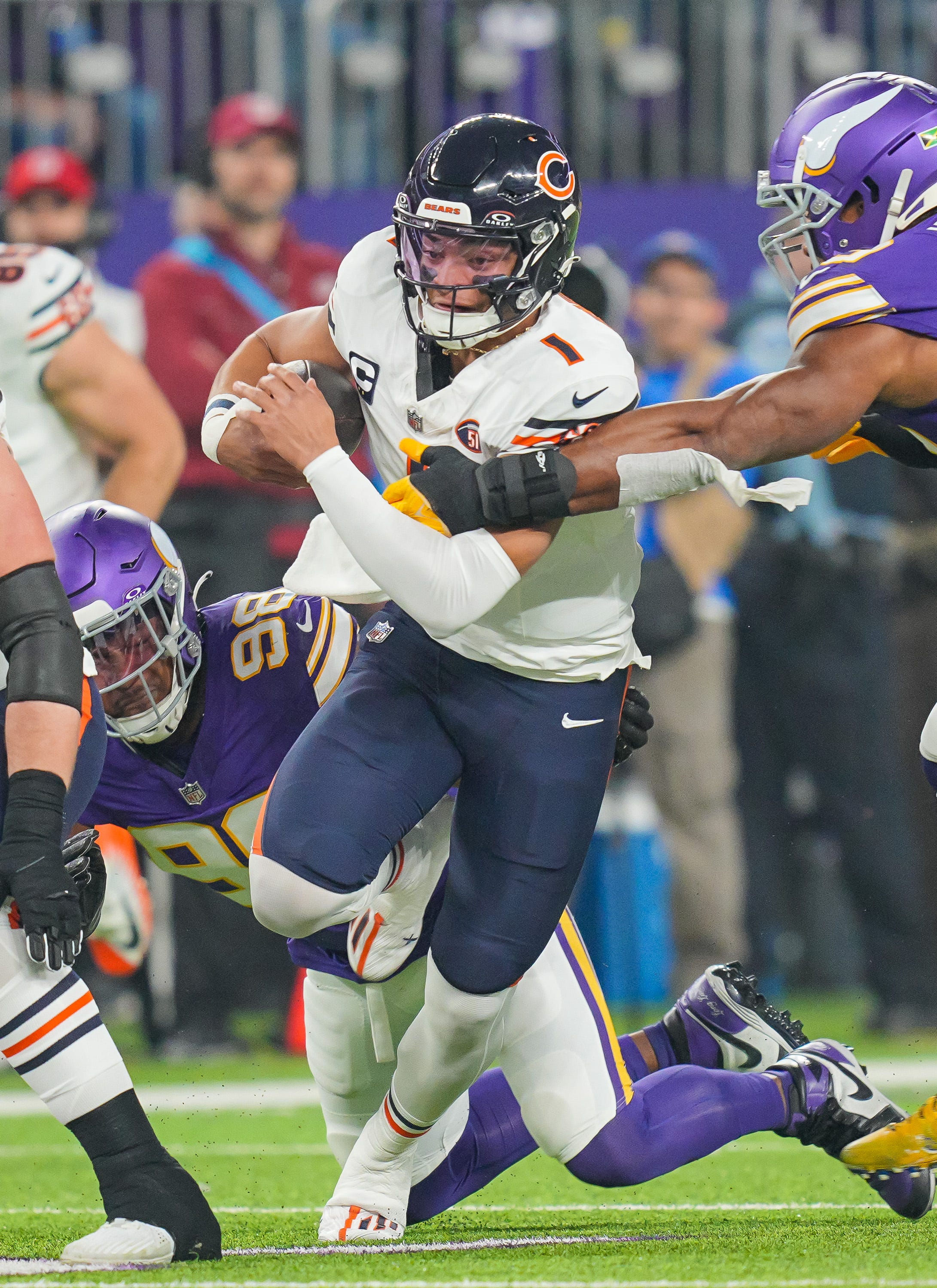 Chicago Bears quarterback Justin Fields (1) scrambles against the Minnesota Vikings.