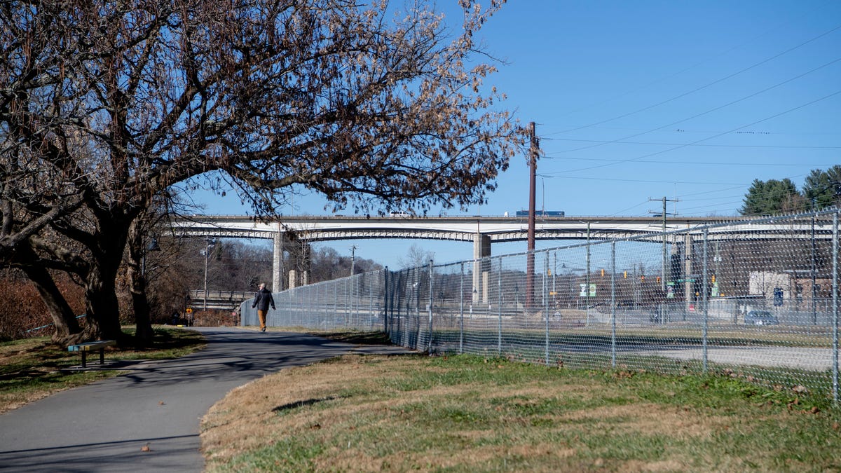 A fence around a parcel of land at 144 Riverside Drive, between the road and Wilma Dykeman Greenway, in the River Arts District.