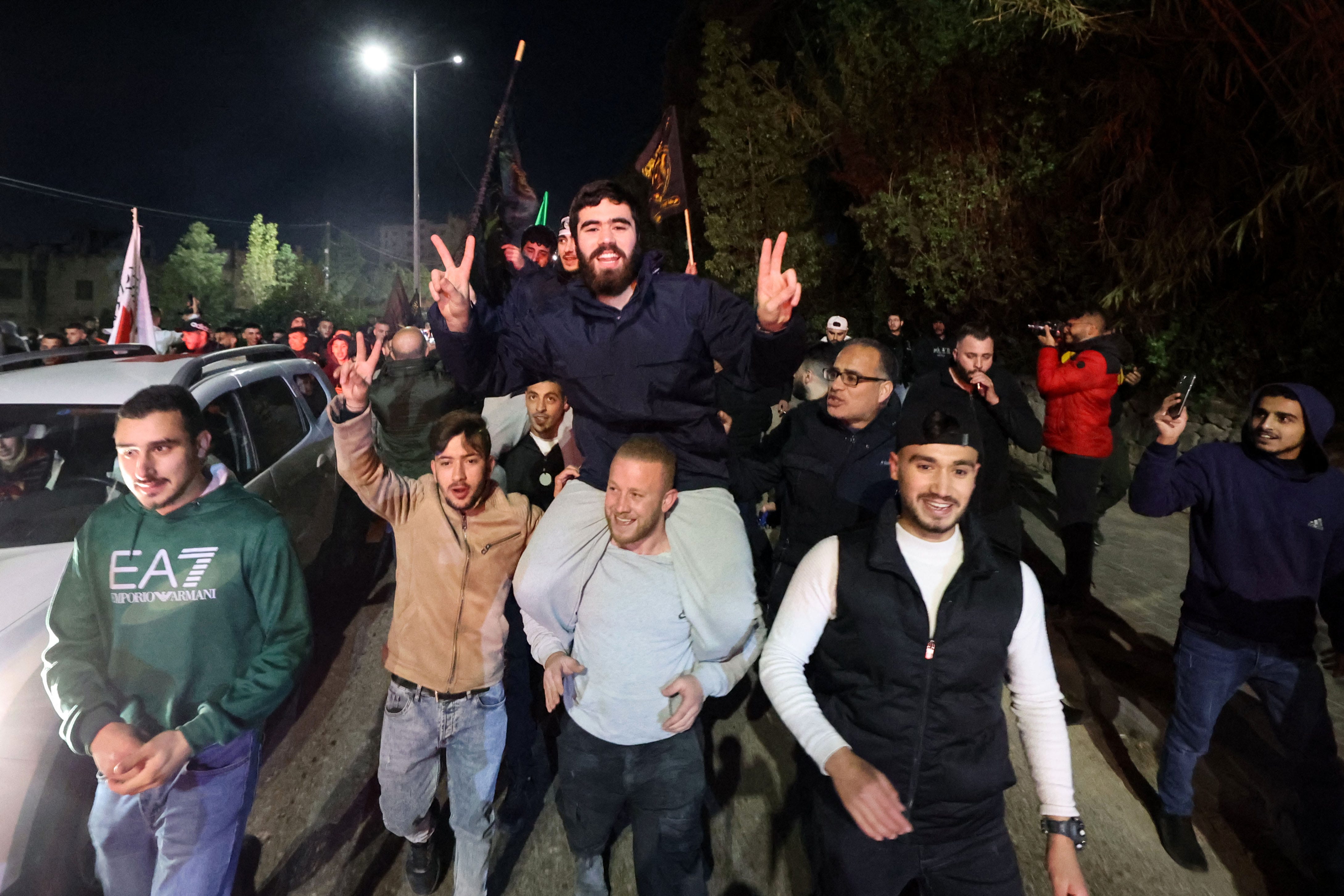 A newly released prisoner is carried by supporters during a welcome ceremony in Ramallah early on Dec. 1, 2023.