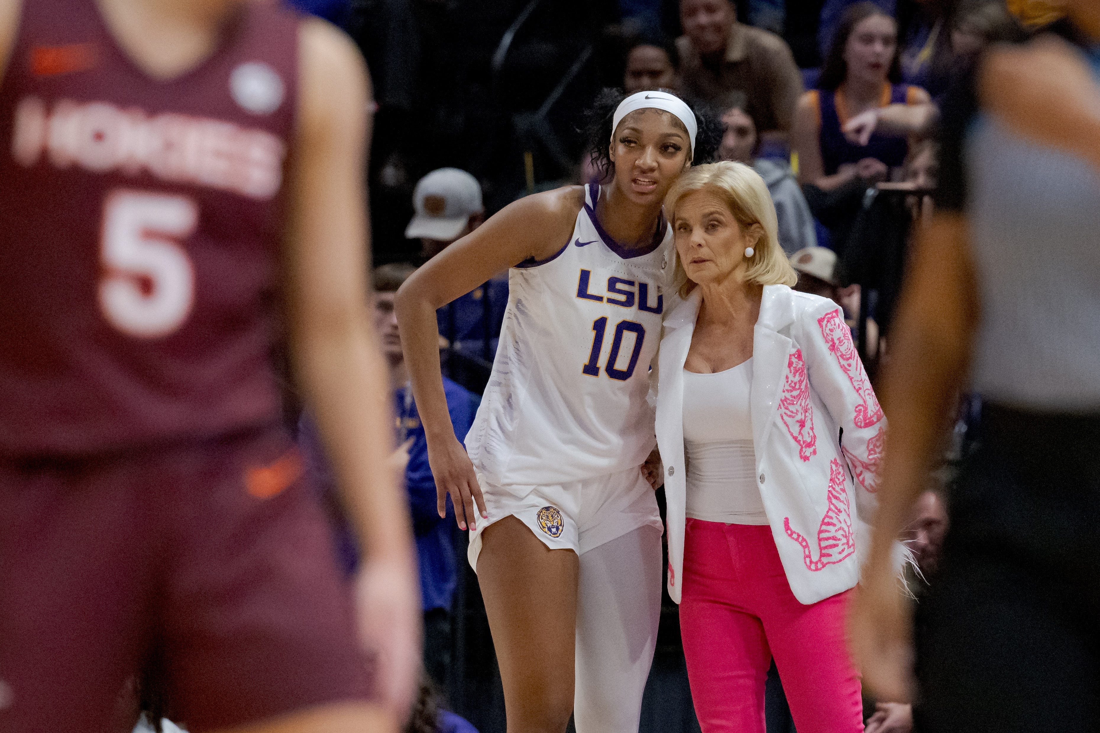 LSU forward Angel Reese talks to coach Kim Mulkey during the game against Virginia Tech.