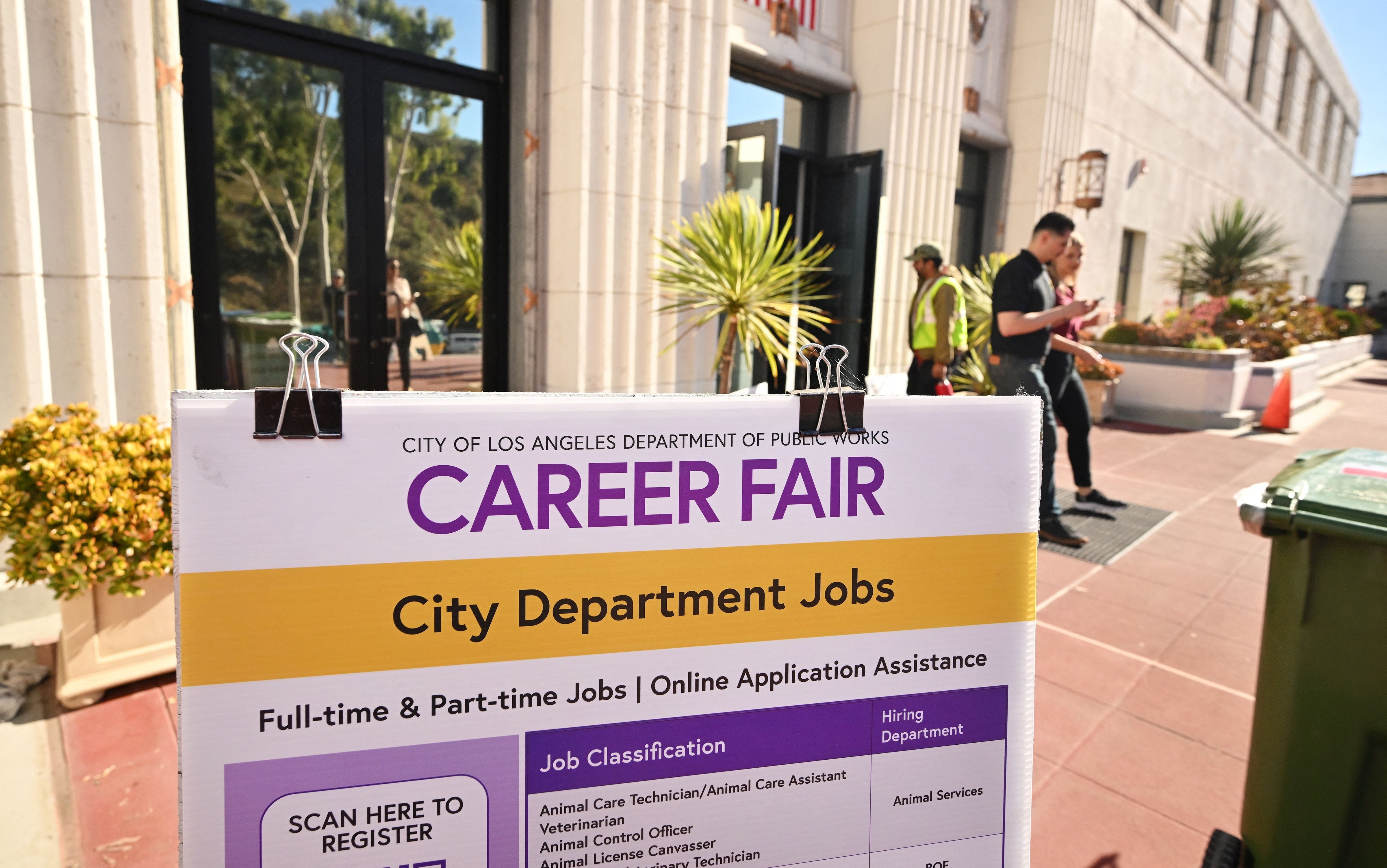 People enter and depart a career fair where job seekers can meet with prospective employers during a City of Los Angeles career fair offering to fill vacancies in more than 30 classifications of jobs on November 2, 2023 in Los Angeles, California. The US Bureau of Labour Statistics will release on November 3 the October jobs report amid expectations employment remains quite healthy. (Photo by Frederic J. BROWN / AFP) (Photo by FREDERIC J. BROWN/AFP via Getty Images)
