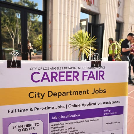 People enter and depart a career fair where job seekers can meet with prospective employers during a City of Los Angeles career fair offering to fill vacancies in more than 30 classifications of jobs on November 2, 2023 in Los Angeles, California. The US Bureau of Labour Statistics will release on November 3 the October jobs report amid expectations employment remains quite healthy. (Photo by Frederic J. BROWN / AFP) (Photo by FREDERIC J. BROWN/AFP via Getty Images)