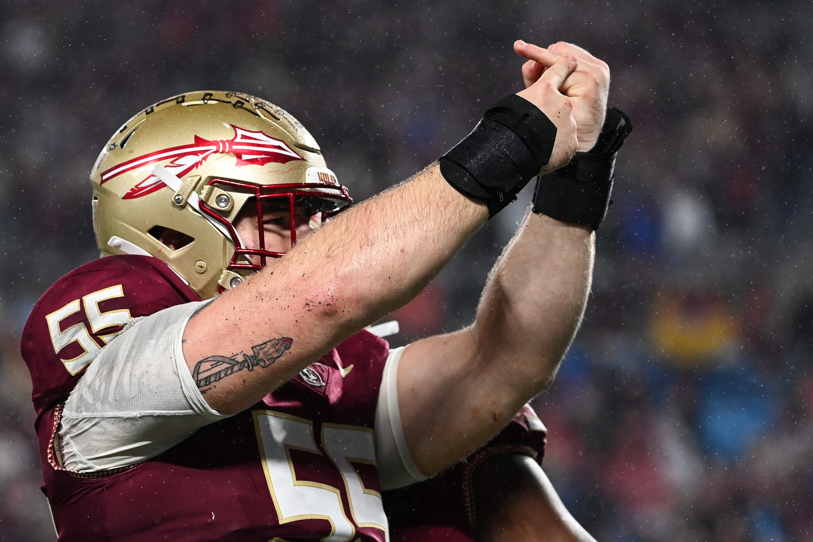 Florida State defensive lineman Braden Fiske points to his ring finger after sacking Louisville quarterback Jack Plummer in the ACC championship game.