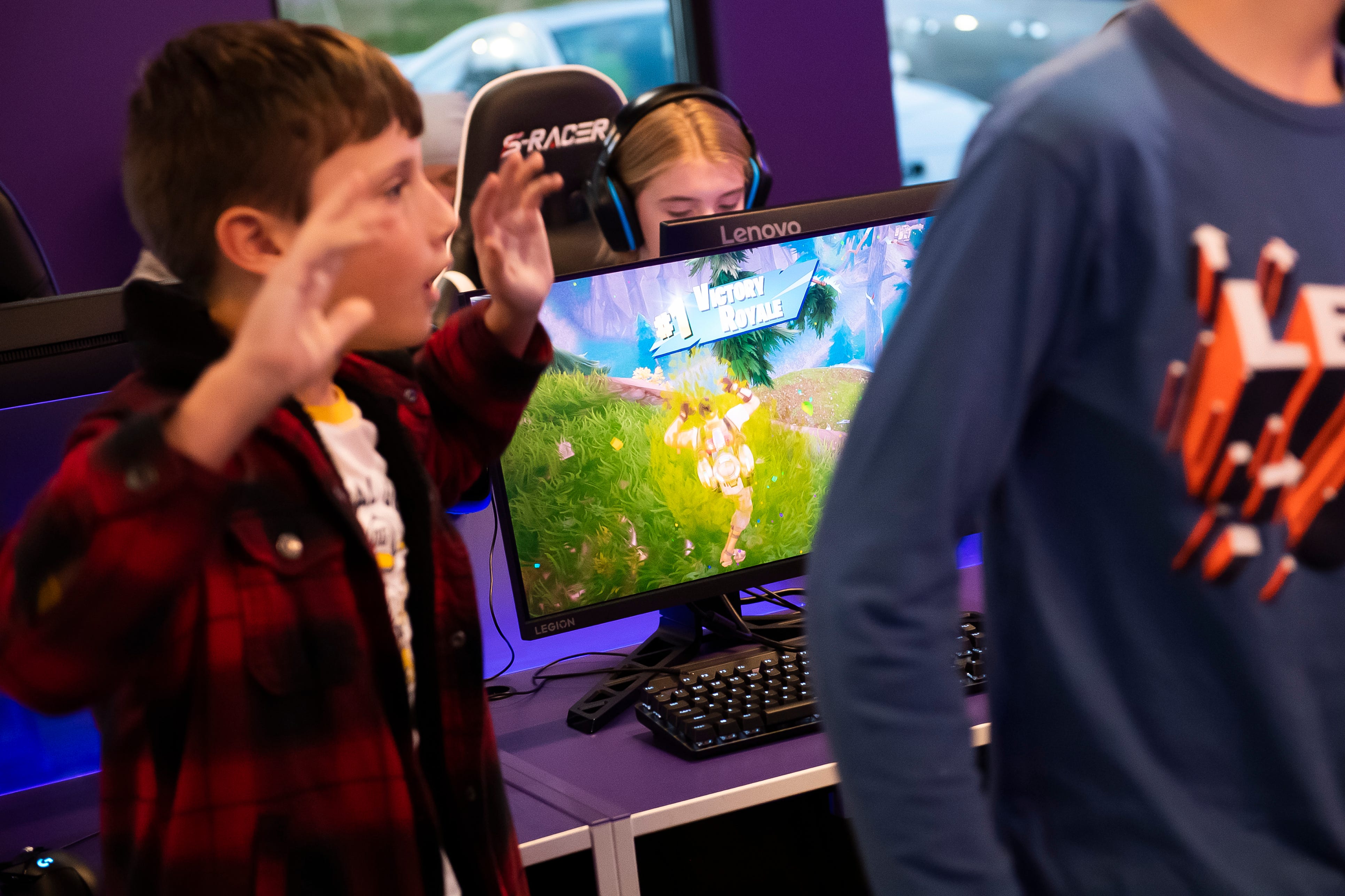 A young gamer reacts with excitement after his friend won a round of Fortnite during a pre-grand opening event at Valhallan Esports Training on Thursday, Nov. 30, 2023, in Camp Hill.