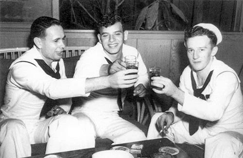 One of the three: Clifford Olds, right, with shipmates Jack Miller, left, and Frank Kosa on the night before Pearl Harbor. Kosa was killed in February 1944.