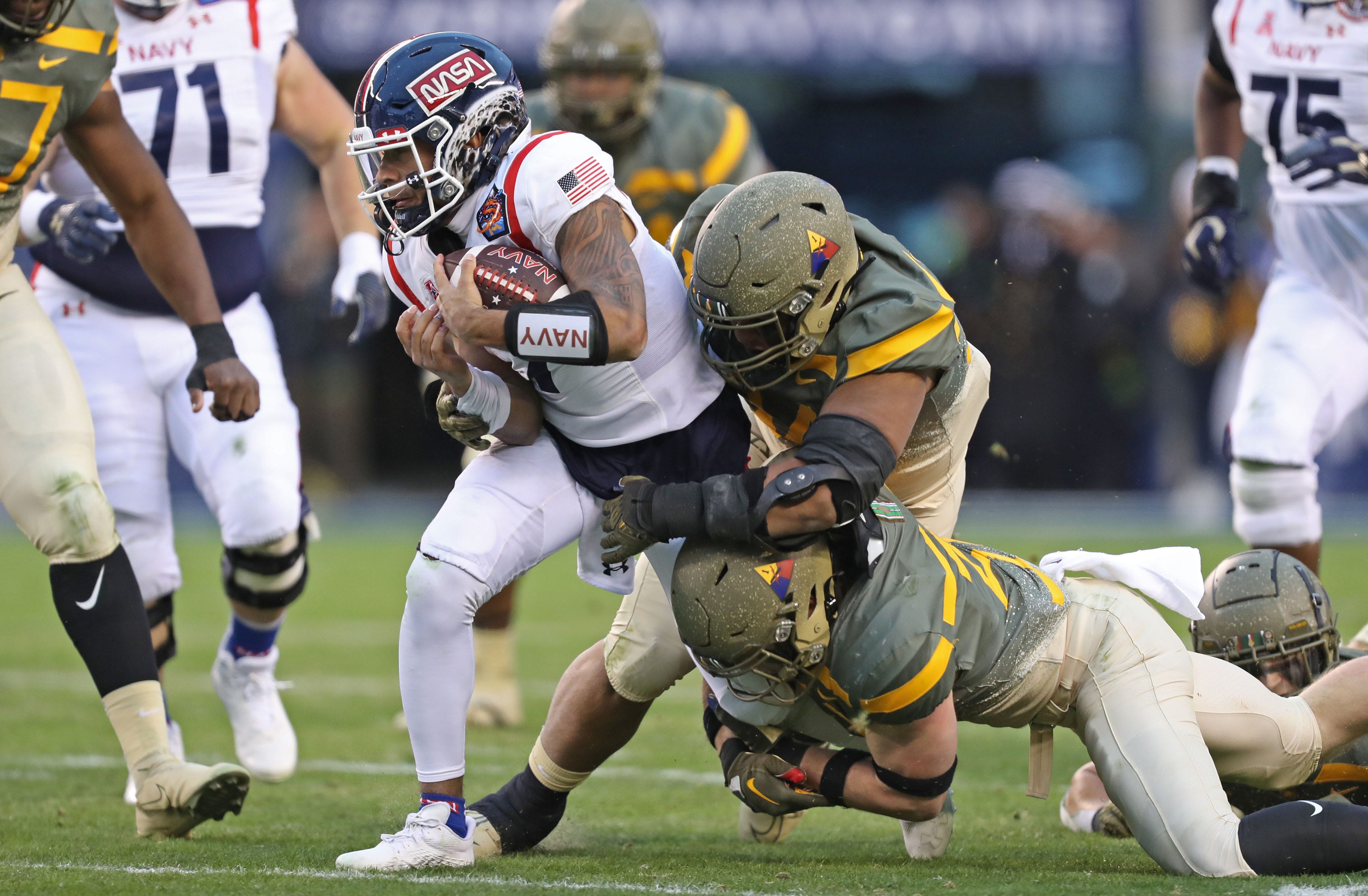 Navy quarterback Xavier Arline (7) carries the ball against Army during the first half of the 123rd Army-Navy game at Lincoln Financial Field.