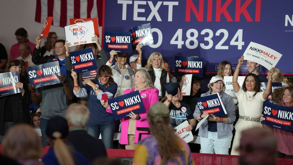Supporters wave signs ahead of a campaign event for GOP presidential hopeful Nikki Haley on Monday, Nov. 27, 2023, in Bluffton, S.C. Haley is among a cluster of Republican candidates competing for second place in a GOP Republican primary thus far largely dominated by former President Donald Trump. (AP Photo/Meg Kinnard) ORG XMIT: SCMK102
