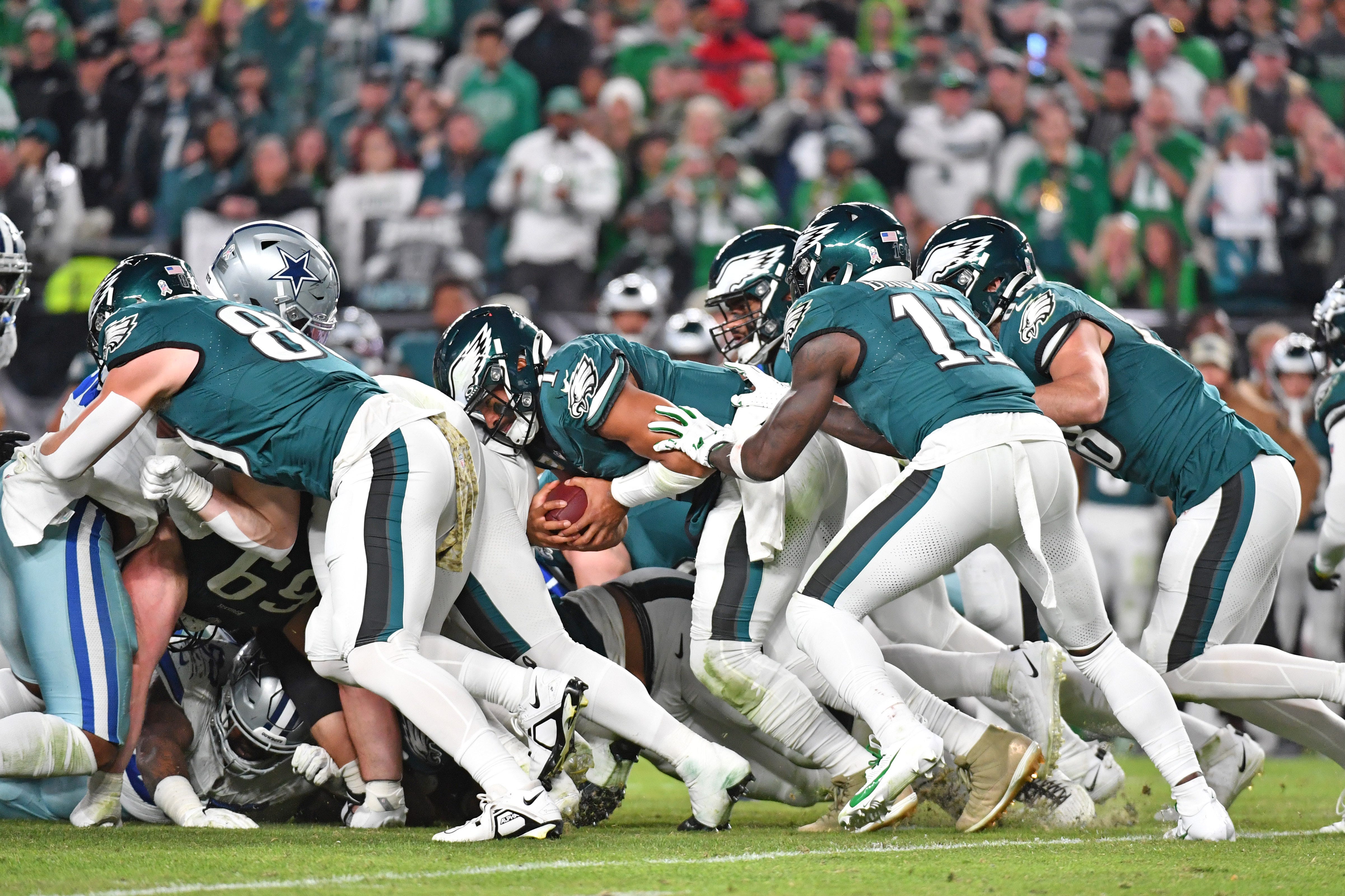 Philadelphia Eagles quarterback Jalen Hurts (1) picks up yardage a first down with a push from wide receiver A.J. Brown (11) and tight end Dallas Goedert (88) against the Dallas Cowboys on Nov 5, 2023 at Lincoln Financial Field.