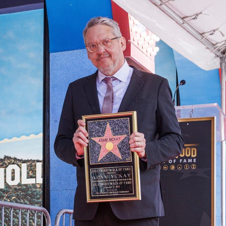 Adam McKay holds a star miniaturette following a ceremony honoring himself with a star on the Hollywood Walk of Fame on Feb. 17, 2022, in Los Angeles.