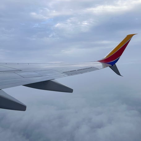 A Southwest plane soars in between clouds en route from New Orleans to Atlanta on Dec. 2, 2023.